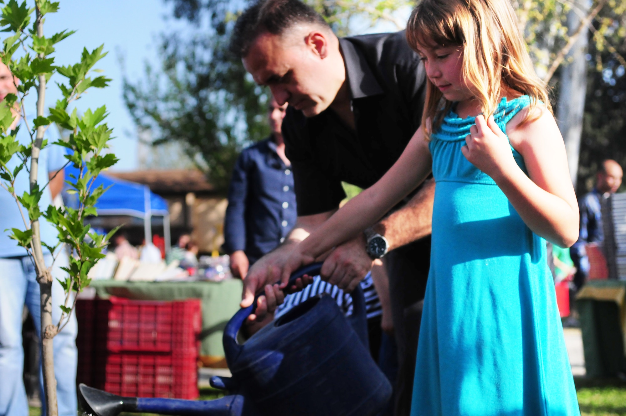 Col. Deniz Kartepe, the commander of the 10th Tanker Command, helps Bailey Matsumura plant a tree for National Sovereignty and Children?s Day during a Children?s Day festival April 17, 2011, at Incirlik Air Base, Turkey. The event was hosted by the Turkish air force 10th Tanker Command and was open to all Incirlik personnel. The event offered an opportunity for camaraderie and partnership-building for all personnel here, and was a chance to celebrate both Turkish children on their national holiday and military children during the Month of the Military Child, officials said.  (U.S. Air Force photo by 1st Lt. Gina McKeen/Released)