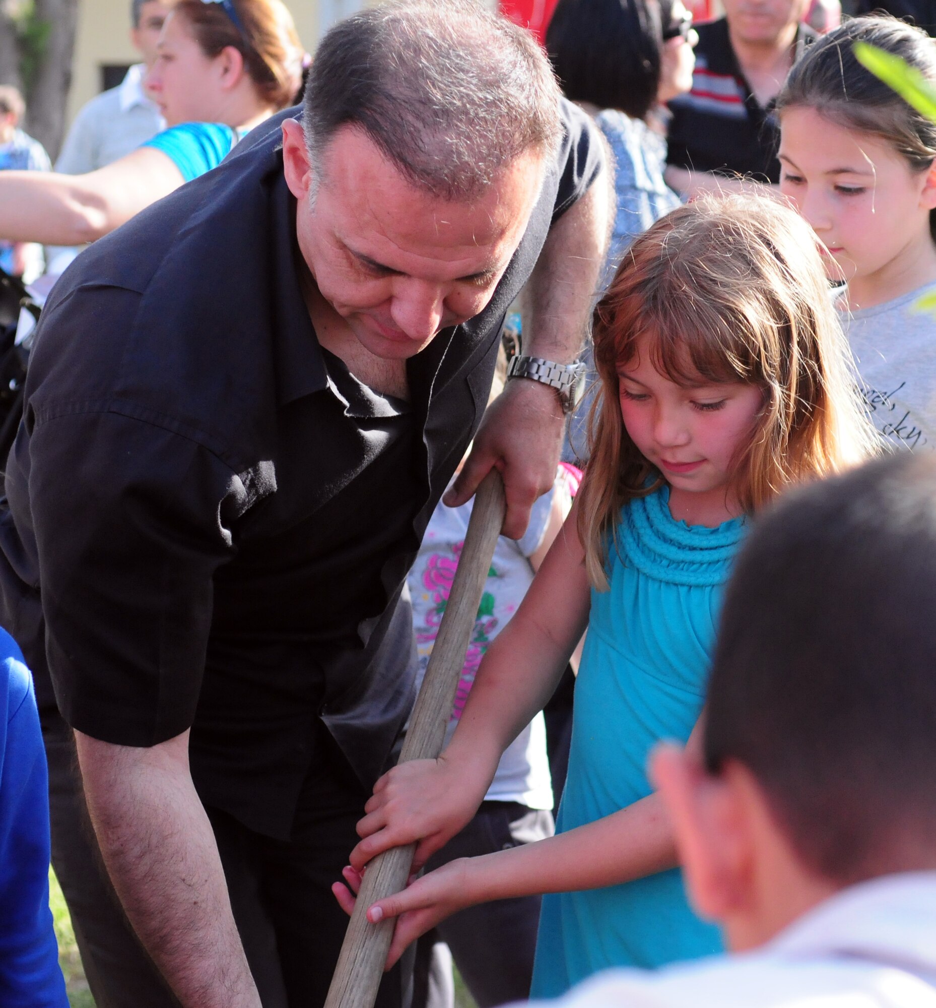 Col. Deniz Kartepe, the commander of the 10th Tanker Command, helps Bailey Matsumura plant a tree for National Sovereignty and Children?s Day during a Children?s Day festival April 17, 2011, at Incirlik Air Base, Turkey. The event was hosted by the Turkish air force 10th Tanker Command and was open to all Incirlik personnel. The event offered an opportunity for camaraderie and partnership-building for all personnel here, and was a chance to celebrate both Turkish children on their national holiday and military children during the Month of the Military Child, officials said.  (U.S. Air Force photo by 1st Lt Gina McKeen/Released)