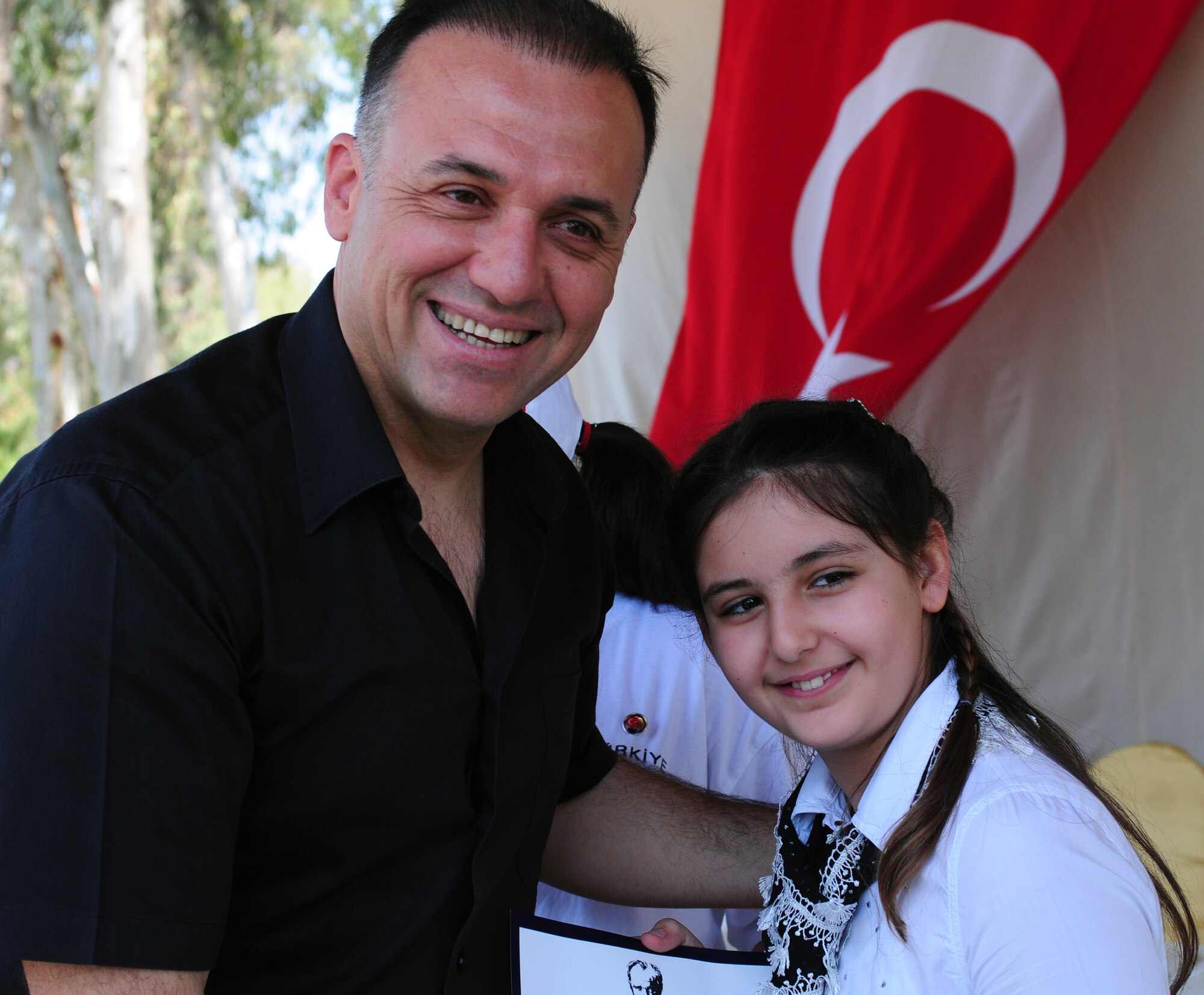 110417-F-BR479-035
Col. Deniz Kartepe, the commander of the 10th Tanker Command, presents a certificate to Doga Altinok for her honorable mention in the National Sovereignty and Children?s Day Art and Poetry contest at a Children?s Day festival April 17, 2011, at Incirlik Air Base, Turkey. The event was hosted by the Turkish air force 10th Tanker Command and was open to all Incirlik personnel. The event offered an opportunity for camaraderie and partnership-building for all personnel here, and was a chance to celebrate both Turkish children on their national holiday and military children during the Month of the Military Child, officials said.  (U.S. Air Force photo by 1st Lt. Gina McKeen/Released)
