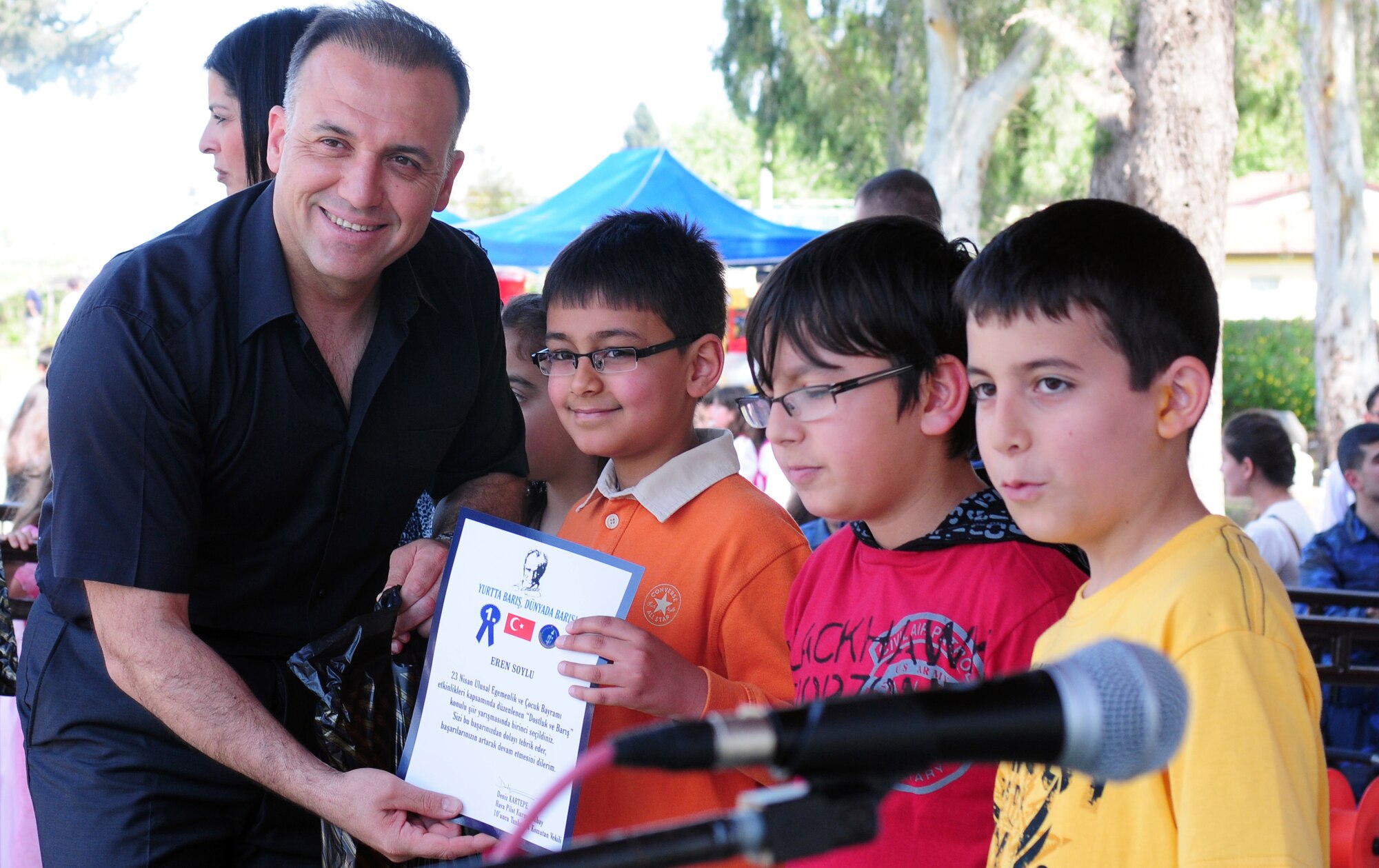 Col. Deniz Kartepe, the commander of the 10th Tanker Command, presents a certificate to Eren Soylu, for his 1st place poem, ?Barish Ve Sevgi? at a Children?s Day festival April 17, 2011, at Incirlik Air Base, Turkey. The event was hosted by the Turkish air force 10th Tanker Command and was open to all Incirlik personnel. The event offered an opportunity for camaraderie and partnership-building for all personnel here, and was a chance to celebrate both Turkish children on their national holiday and military children during the Month of the Military Child, officials said.  (U.S. Air Force photo by 1st Lt. Gina McKeen/Released)