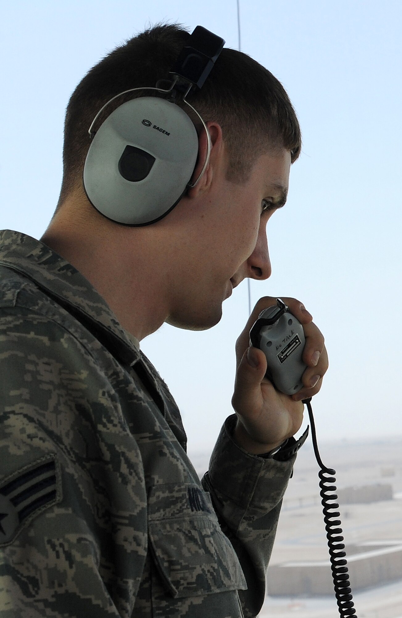 Senior Airman John Nickel gives taxiing instructions to an aircraft at an undisclosed location in Southwest Asia on April 20. Airman Nickel is deployed to the 379th Expeditionary Operations Squadron from Dover AFB, Del. (U.S. Air Force photo/Staff Sgt. Liliana Moreno)                                                 