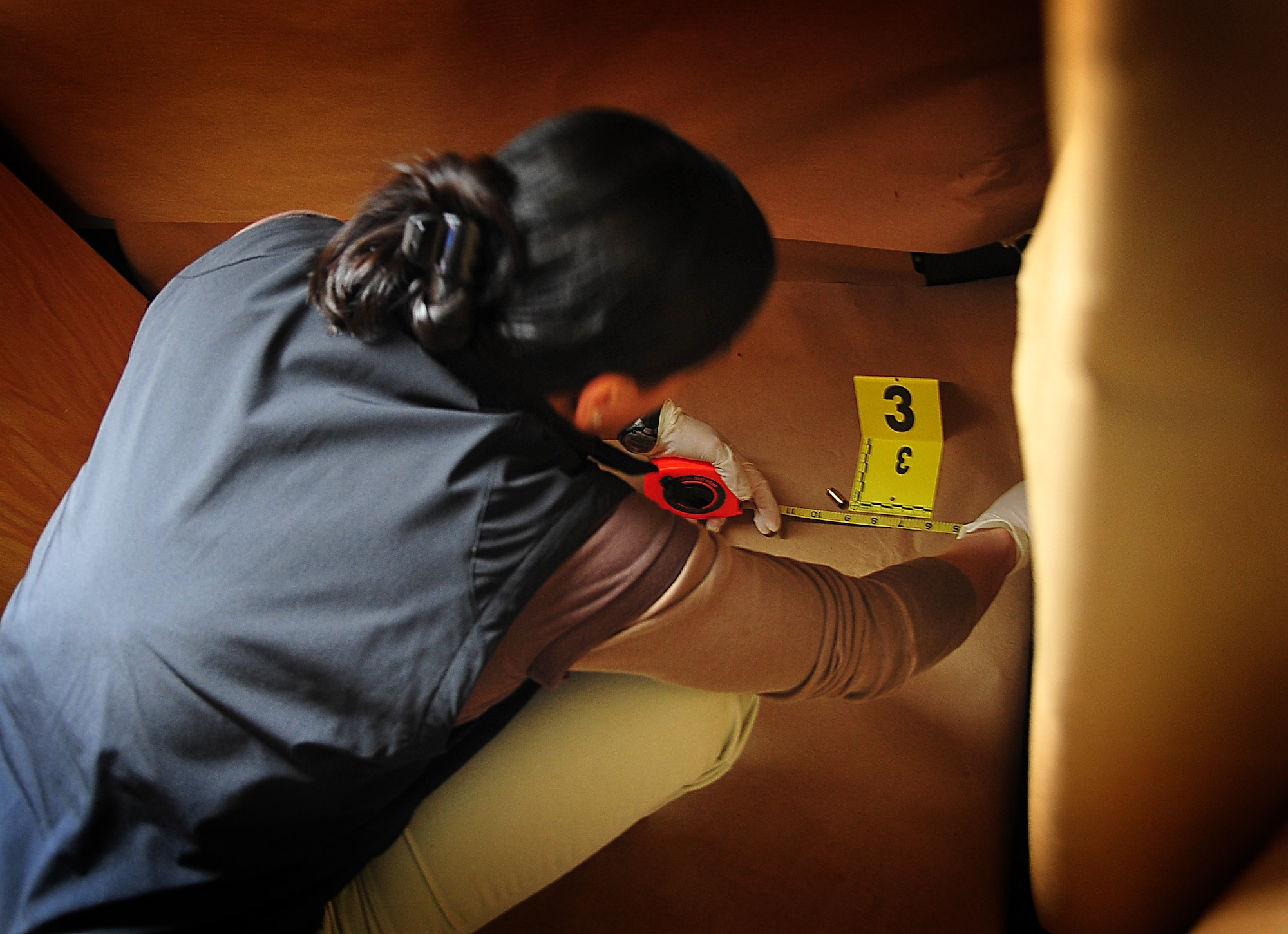 The Air Force Office of Special Investigations held an annual Crime Scene Investigation/ Active shooter exercise, here, April 27.   The scene was prepared with sheep’s blood and a moulaged dummy victim.   A husband returning from deployment, has Post Traumatic Stress Disease, kills his wife and abducts his child fleeing the dead wife scene.  The neighbor hears the shots and phones 911.   At the simulated residence, Bldg 930, Security Forces cleared the residence and OSI processed the scene gathering evidence.  The suspect killed his child and an active shooter incident took place.  This exercise helped field agents sharpen their CSI skills. (U.S. Air Force Photo by Staff Sgt. Daylena Gonzalez)