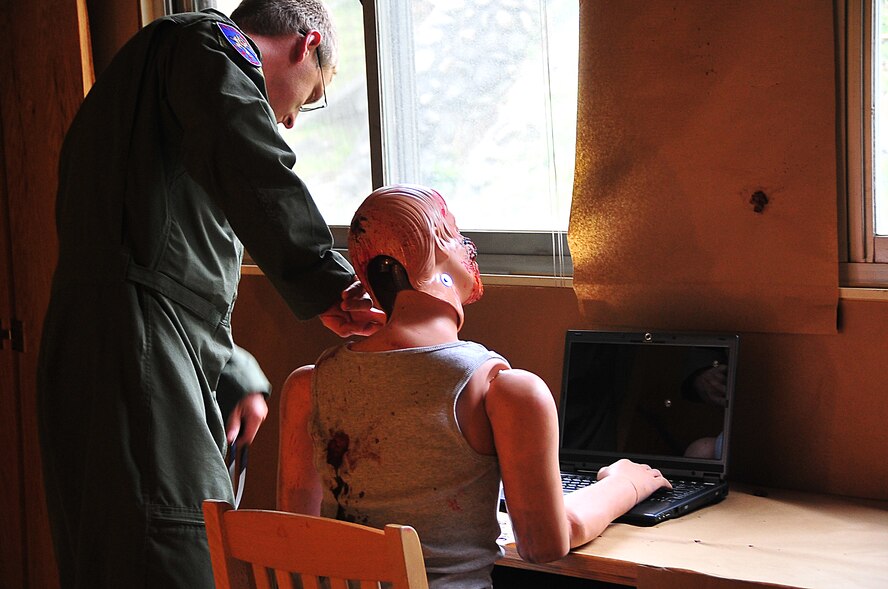 The Air Force Office of Special Investigations held an annual Crime Scene Investigation/ Active shooter exercise, here, April 27.   The scene was prepared with sheep’s blood and a moulaged dummy victim.   A husband returning from deployment, has Post Traumatic Stress Disease, kills his wife and abducts his child fleeing the dead wife scene.  The neighbor hears the shots and phones 911.   At the simulated residence, Bldg 930, Security Forces cleared the residence and OSI processed the scene gathering evidence.  The suspect killed his child and an active shooter incident took place.  This exercise helped field agents sharpen their CSI skills. (U.S. Air Force Photo by Staff Sgt. Daylena Gonzalez)