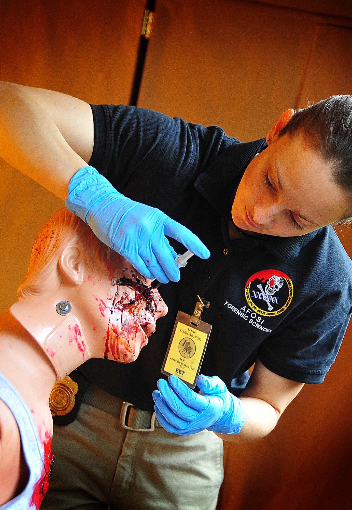 The Air Force Office of Special Investigations held an annual Crime Scene Investigation/ Active shooter exercise, here, April 27.   The scene was prepared with sheep’s blood and a moulaged dummy victim.   A husband returning from deployment, has Post Traumatic Stress Disease, kills his wife and abducts his child fleeing the dead wife scene.  The neighbor hears the shots and phones 911.   At the simulated residence, Bldg 930, Security Forces cleared the residence and OSI processed the scene gathering evidence.  The suspect killed his child and an active shooter incident took place.  This exercise helped field agents sharpen their CSI skills. (U.S. Air Force Photo by Staff Sgt. Daylena Gonzalez)
