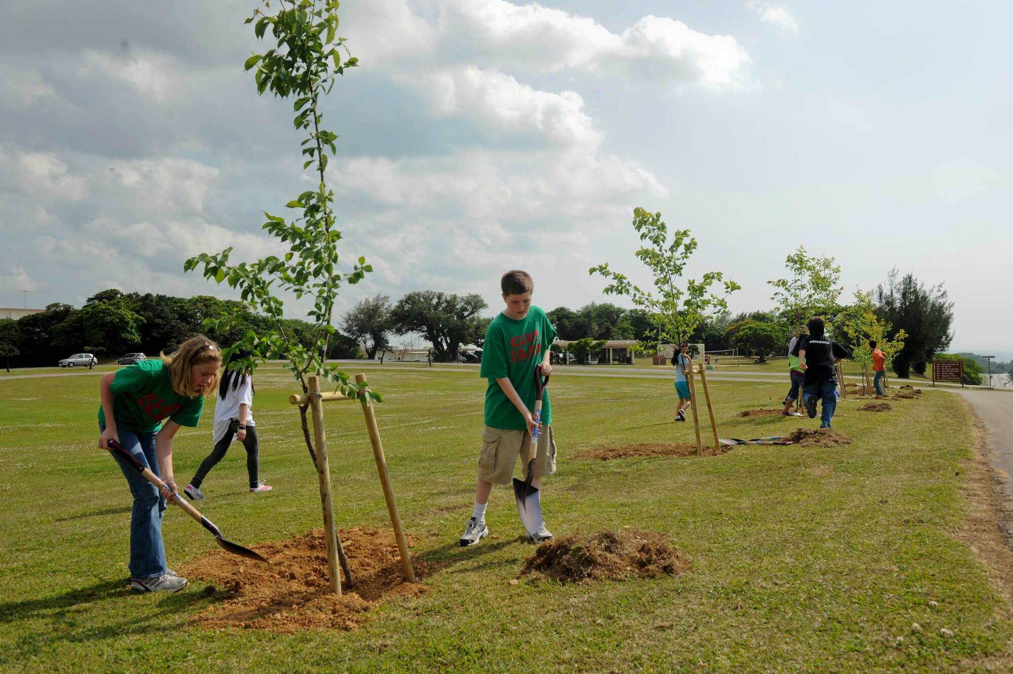 Students from the Zoological Enviromental Research Opportunity Club at Kadena Middle School plant cherry blossom trees at Marek Park April 22. The tree planting was part of an act of green for Earth Week that runs April 17-24. (U.S. Air Force photo/Staff Sgt. Jonathan Steffen)