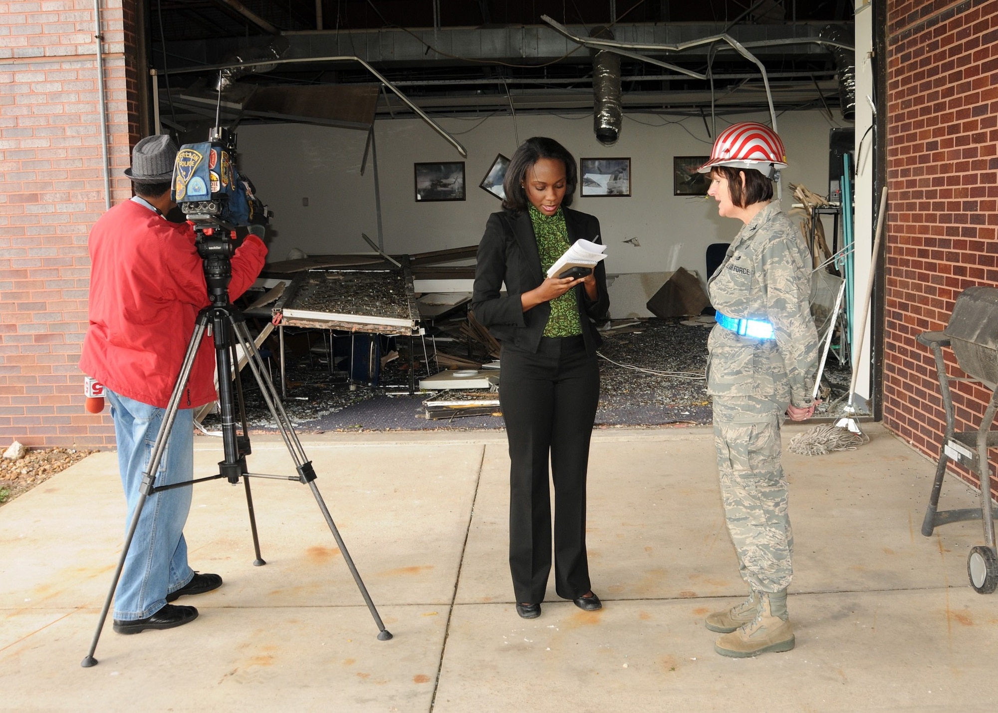 Colonel Kathleen Hancox, 131st Mission Support Group Commander and Emergency Operations Center Director, is interviewed by Ms. Courtney Gousman, a broadcast journalist with KSDK News Channel 5, regarding continued cleanup efforts at the 131st Bomb Wing Missouri Air National Guard Base at Lambert Field-Saint Louis, April 26.  A category EF4 tornado swept across the Base, April 22. No injuries were reported to Air National Guard personnel, but there was widespread damage across the south-side of the base. Estimates for repair to the base could top 10 million U.S. dollars.  Cleanup efforts at the base are ongoing. (Photo by Master Sgt. Mary-Dale Amison)