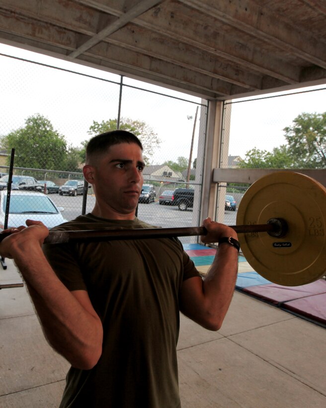 Staff Sgt. Ryan Leonard, training staff noncommissioned officer in charge at  Headquarters Battalion, 4th Marine Division, performs jerk and clears during an April 27 Cross Fit Red Diamond session.  Born as a predeployment conditioning program for the Marines of the 4th Marine Division in the summer of 2009, Cross Fit Red Diamond has evolved into a permanent physical training program that attracts a steady following of fitness aficionados from across Marine Forces Reserve Headquarters as well as a number of base security and civilian workers. ::r::::n::(Official Marine Corps photo by Cpl. Jad Sleiman)::r::::n::