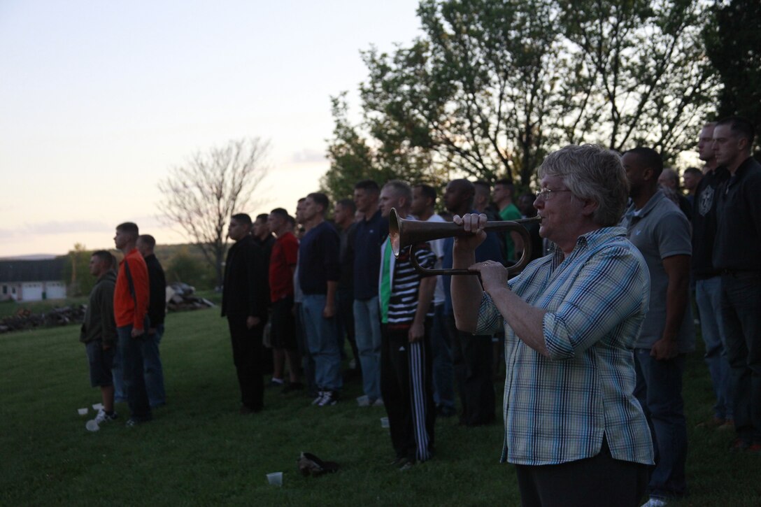 As the sun dips below the horizon in Gettysburg, Pa., April 28, roughly 70 Marines from Marine Wing Support Squadron 271 stand at attention as Linda Bell plays “Taps” on the bugle, in chilling remembrance of the more than 50,000 lives lost near where the Marines stood. The Marines visited Gettysburg and camped at the Garrahy home April 27-29 to strengthen their cohesion as enlisted leaders.