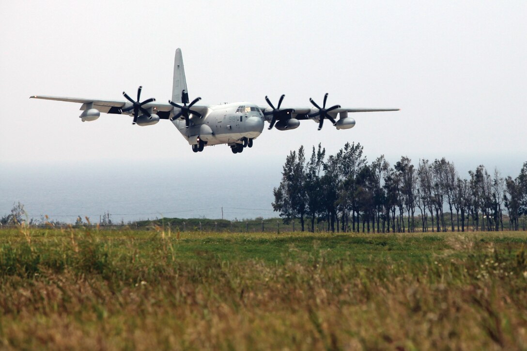 A KC130-J Super Hercules aircraft lands during a training exercise on Ie Shima training facility, managed by a small detachment of Marines. The facility is used for training evolutions such as AV-8B Harrier aircraft takeoff and landing exercises and human and cargo parachute drop training.