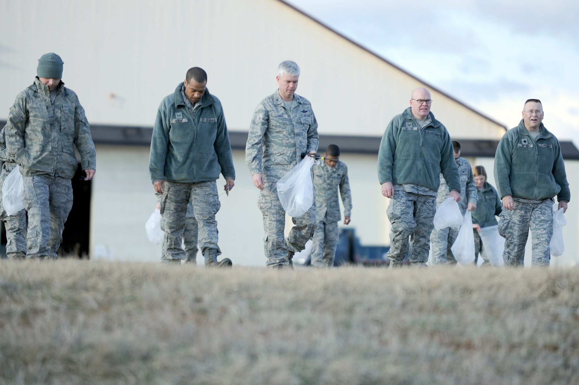 MISAWA AIR BASE, Japan -- Col. Al Wimmer, 35th Fighter Wing vice commander, center, joins Airmen and Sailors as they collect foreign object damage on the airfield April 29. An annual FOD walk is held in order pick up potential safety hazards that could possibly affect Misawa's aircraft and people. (U.S. Air Force photo/Staff Sgt. Marie Brown/Released)