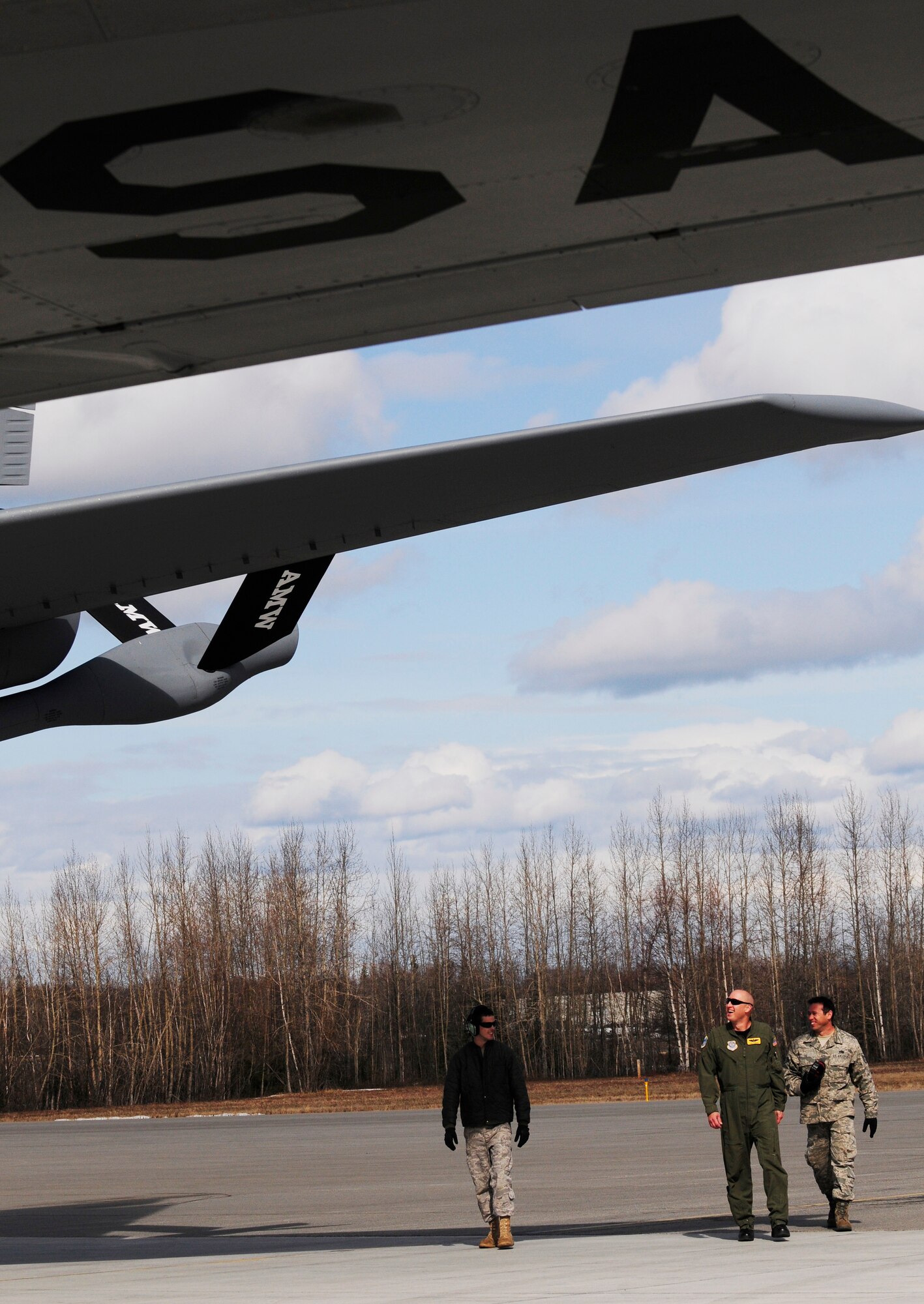Capt. Rob Akman and crew chiefs perform a final safety inspection of a KC-135 Stratotanker before an air refueling mission in support of RED FLAG-Alaska 11-1 April 26, 2011, Eielson Air Force Base, Alaska.  RF-A is a Pacific Air Forces-directed field training exercise for United States and allied forces to train under simulated air-combat situations in the Joint Pacific Alaska Range Complex with over 67,000 square miles of air space, more than 30 threat simulators, one conventional bombing range, and two tactical bombing ranges containing more than 400 different types of targets. Captain Akman is assigned to the 126th Air Refueling Wing, 906th Air Refueling Squadron, Scott Air Force Base, Ill. and the crew chiefs are assigned to the 154th Aircraft Maintenance Squadron, Hickam Air Force Base, Hawaii. (U.S. Air Force photo/Airman 1st Class Laura Goodgame)