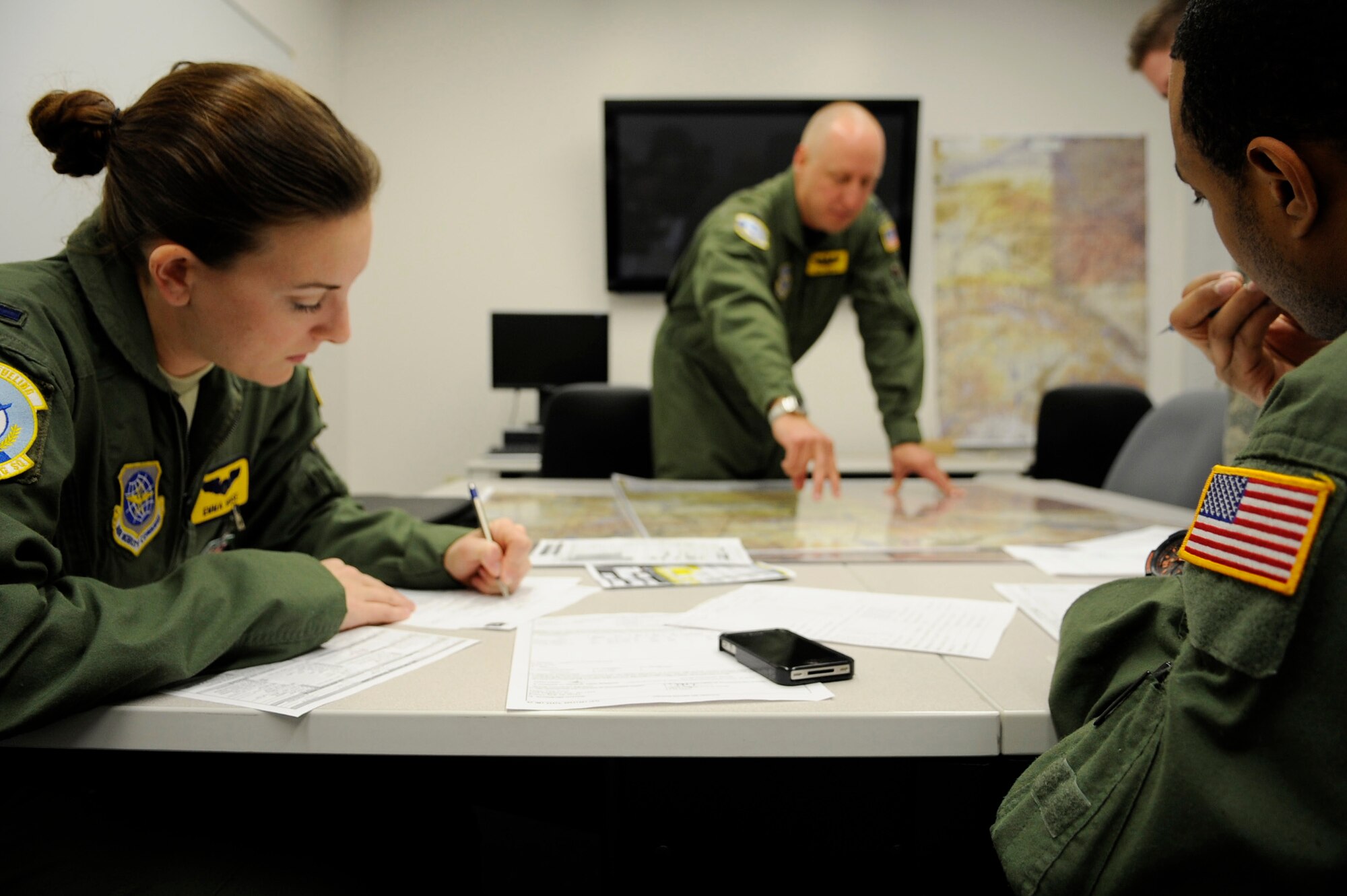 Aircrew Airmen review last minute details before their air refueling mission in support of RED FLAG-Alaska 11-1 April 26, 2011, Eielson Air Force Base, Alaska.  RF-A is a Pacific Air Forces-directed field training exercise for United States and allied forces to train under simulated air-combat situations in the Joint Pacific Alaska Range Complex with over 67,000 square miles of air space, more than 30 threat simulators, one conventional bombing range, and two tactical bombing ranges containing more than 400 different types of targets. The Airmen are assigned to the 126th Air Refueling Wing, 906th Air Refueling Squadron, Scott Air Force Base, Ill. (U.S. Air Force photo/Airman 1st Class Laura Goodgame) 