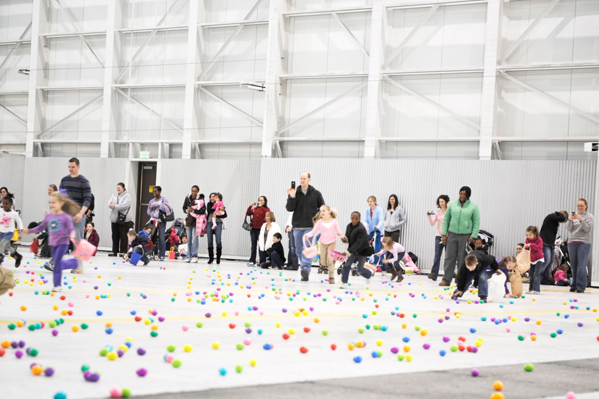 Joint Base Elmendorf-Richardson hosted Easter festivities for children at the Easter Eggstravaganza April 23. Army and Air Force families alike came out to gather prize-filled eggs and socialize with food and drink while visiting with the Easter bunny and celebrating spring. Families at Hangar 20 race for eggs April 23 at the JBER Eggstravaganza in celebration of Easter. (U.S. Air Force photo\Steve White)