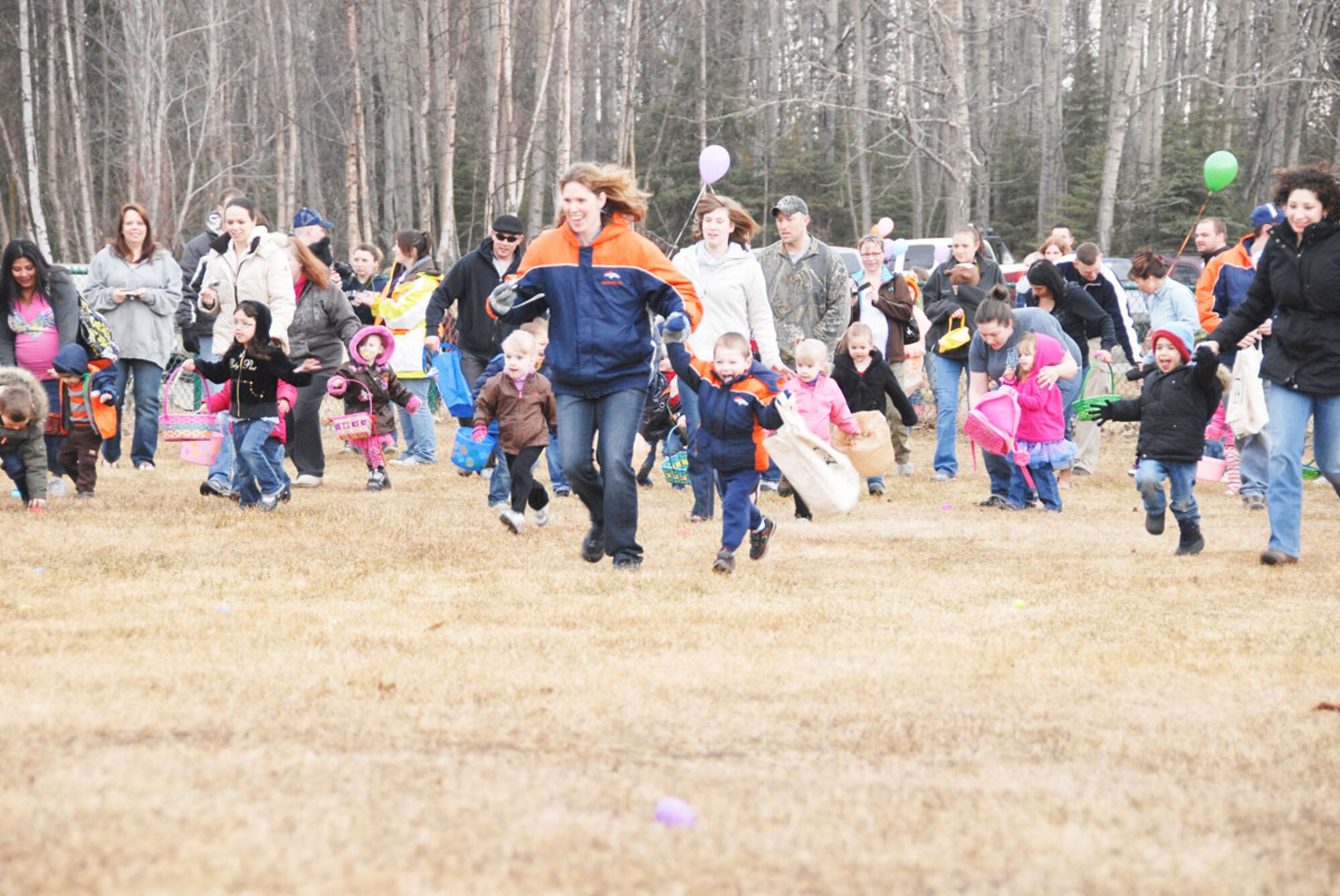 Joint Base Elmendorf-Richardson hosted Easter festivities for children at the Easter Eggstravaganza April 23. Army and Air Force families alike came out to gather prize-filled eggs and socialize with food and drink while visiting with the Easter bunny and celebrating spring. Families on JBER-Richardson gather plastic Easter eggs at Cottonwood Park. Cool, cloudy weather did not distract children from the prize-filled eggs and candy, or the events at the Arctic Oasis after the egg-grabbing ended.
 (U.S. Air Force photo\Steve White)