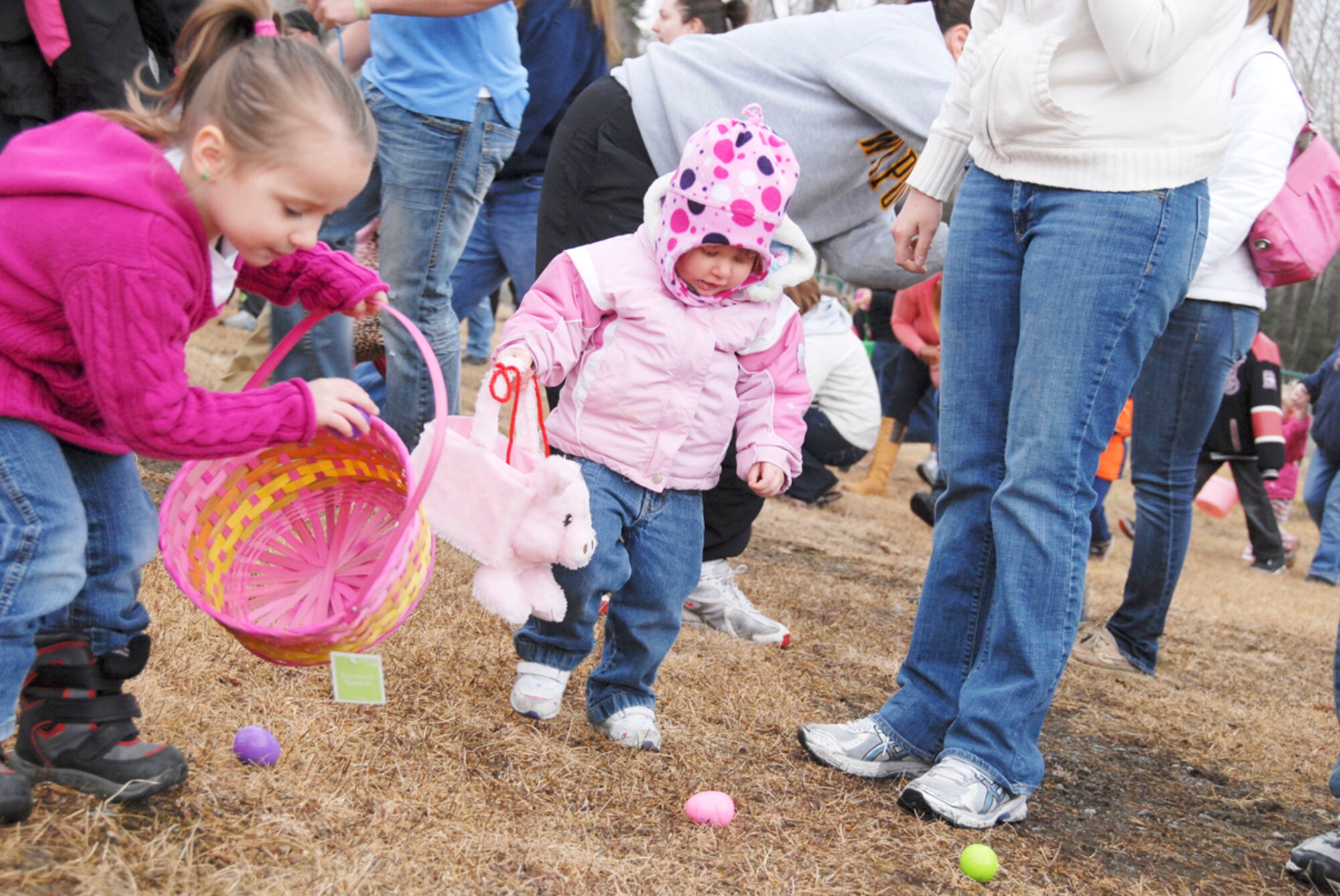 Joint Base Elmendorf-Richardson hosted Easter festivities for children at the Easter Eggstravaganza April 23. Army and Air Force families alike came out to gather prize-filled eggs and socialize with food and drink while visiting with the Easter bunny and celebrating spring. Macy Dallefeld, daughter of Sgt. Jonathan Dullefeld, Headquarters and Headquarters Company, 725th Brigade Support Battalion, finds a egg to match her outfit  at annual egg hunt. (U.S. Air Force photo\Steve White)