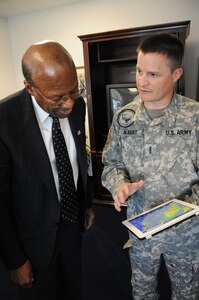 Dr. Clifford Stanley, Under Secretary of Defense for Personnel and Readiness, is briefed on weather conditions in the South Eastern United States by Army Chief Warrant Officer 4 Michael Albert at Randolph Air Force Base, Texas, April 27. Warrant Officer Albert is assigned to Fort Hood, Texas.(U.S. Air Force photo/Melissa Peterson)