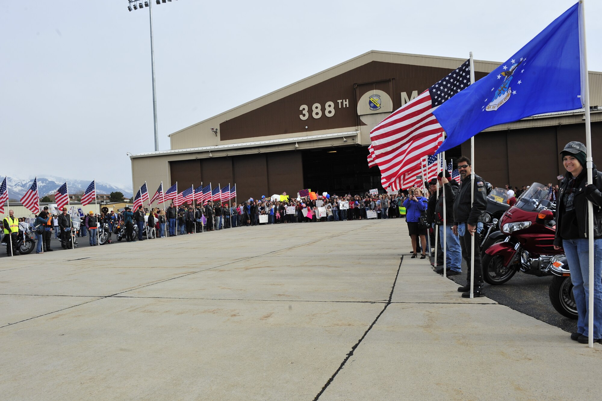 Family and friends gather on the flight line and await their loved ones’ return. The returning Airmen deployed in September 2010, maintaining security and stability in Afghanistan in support of Operation Enduring Freedom. (U.S. Air Force photo/Kim Cook)