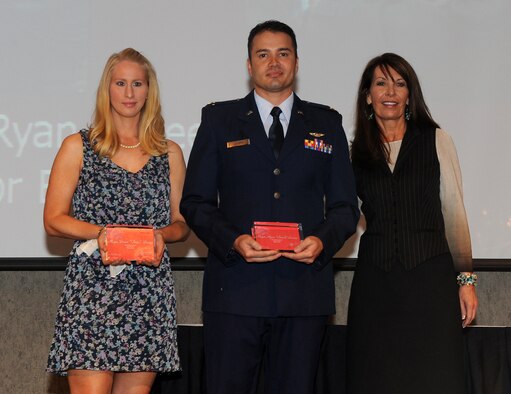 Lydia Bragg (left) accepts the Military Hero Award in behalf of her husband, Maj. Brian Bragg as Vickie van der Have, president of Weber State Credit Union presents the award to Maj. Ryan Lucero. ( U.S. Air Force photo by Alex Lloyd)