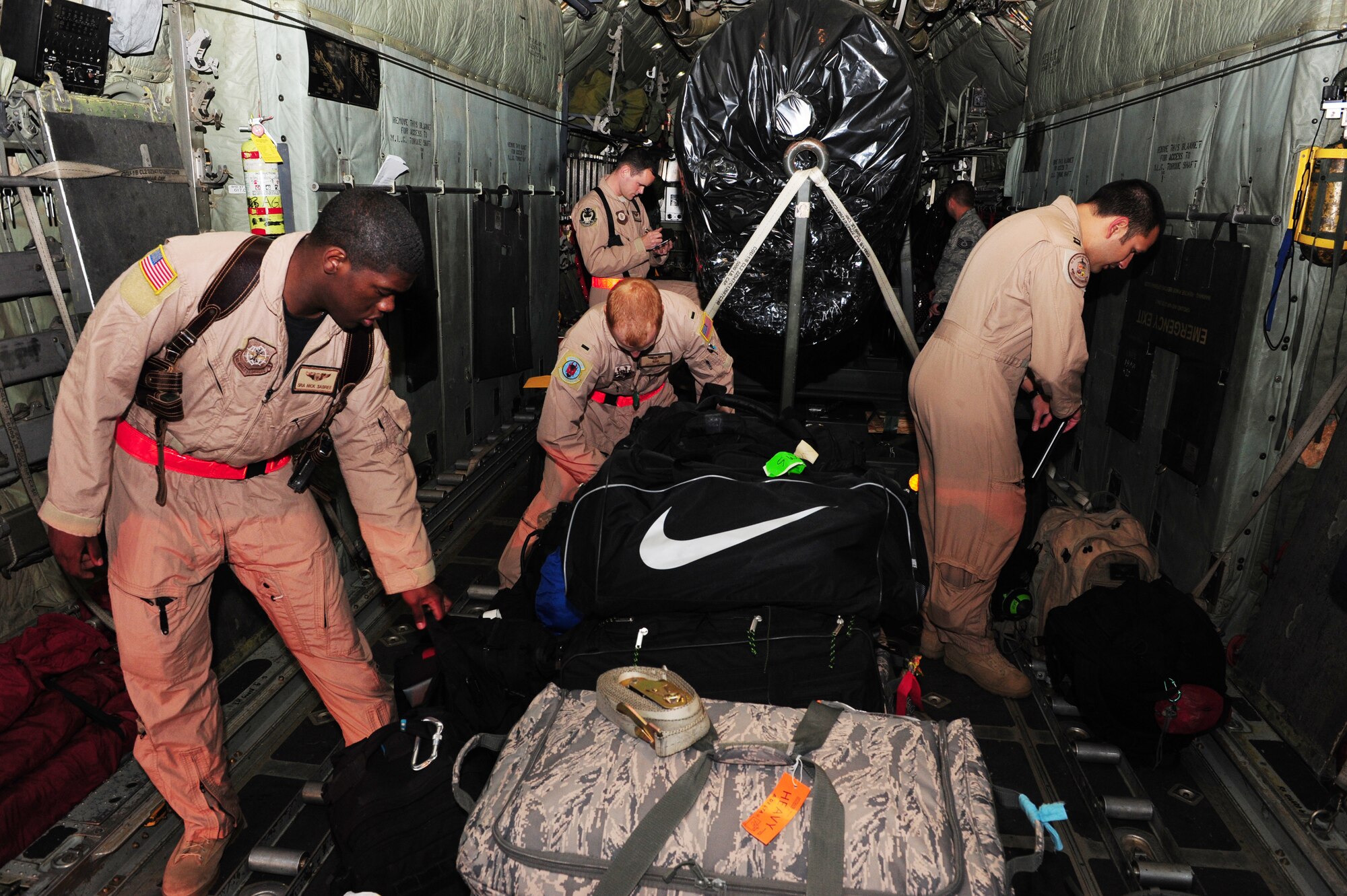 Airmen from the 50th Airlift Squadron strap their bags before they deploy on April 28, 2011, at Little Rock Air Force Base, Ark. Airmen and aircraft from the 50th Airlift Squadron “Red Devils” leave for deployment to Southwest Asia. This is the first deployment of Airmen and aircraft from Little Rock Air Force Base following an F-2 tornado that struck the base the evening of April 25 and damaged more than 100 on-base housing units, damaged three C-130 aircraft and blew the roofs off and damaged many buildings in the base's flightline area. (U.S. Air Force photo by Senior Airman Jim Araos)