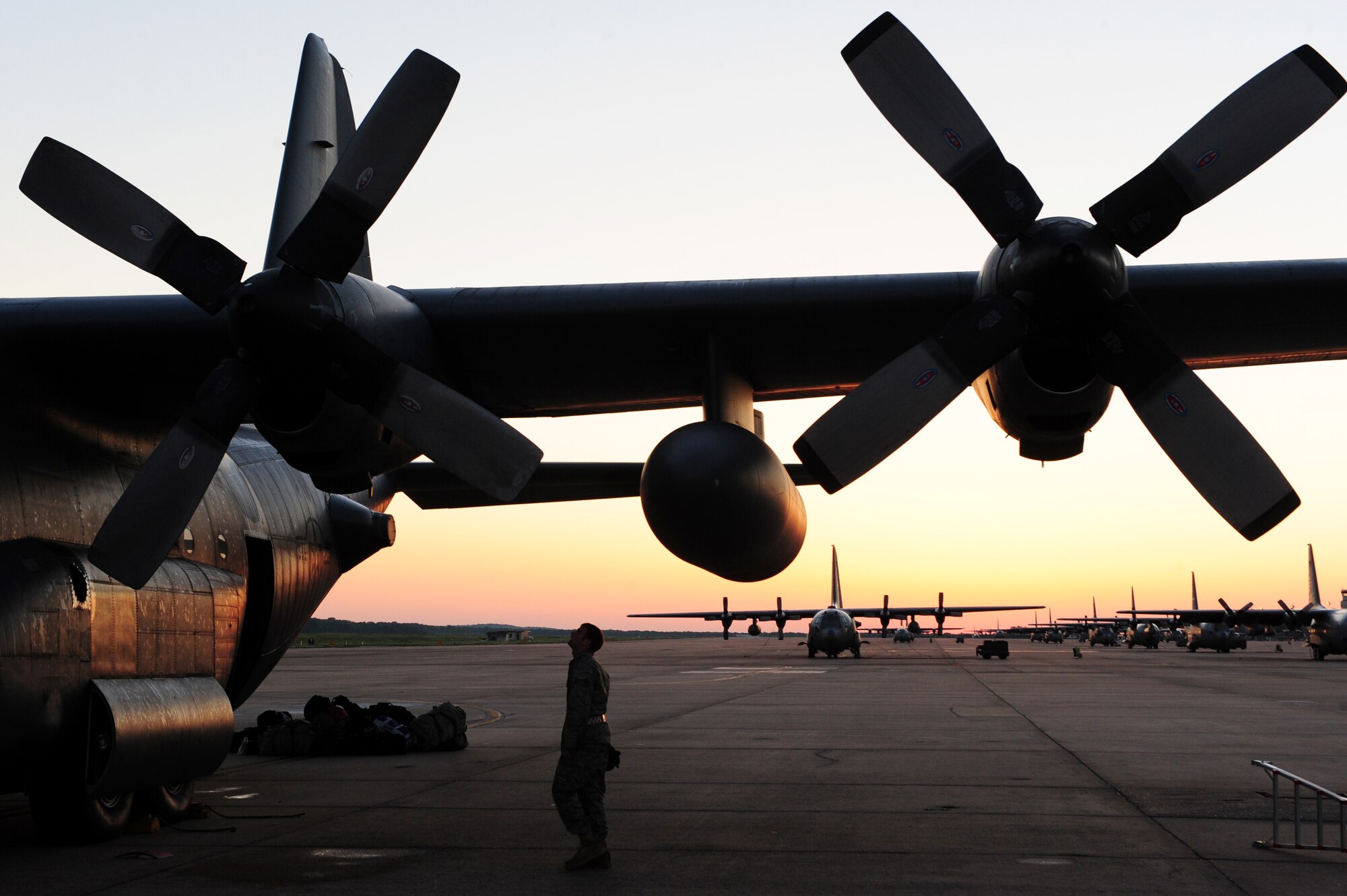 An Airman from the 50th Airlift Squadron performs a preflight inspection before he deploys on April 28, 2011, at Little Rock Air Force Base, Ark. Airmen and aircraft from the 50th Airlift Squadron “Red Devils” leave for deployment to Southwest Asia. This is the first deployment of Airmen and aircraft from Little Rock Air Force Base following an F-2 tornado that struck the base the evening of April 25 and damaged more than 100 on-base housing units, damaged three C-130 aircraft and blew the roofs off and damaged many buildings in the base's flightline area. (U.S. Air Force photo by Senior Airman Jim Araos)