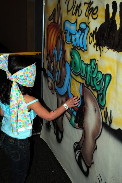 Amanda Campos, 4, just misses the target for the pin the tail on the donkey game.  (U.S. Air Force photo/Airman Cortney Hansen)