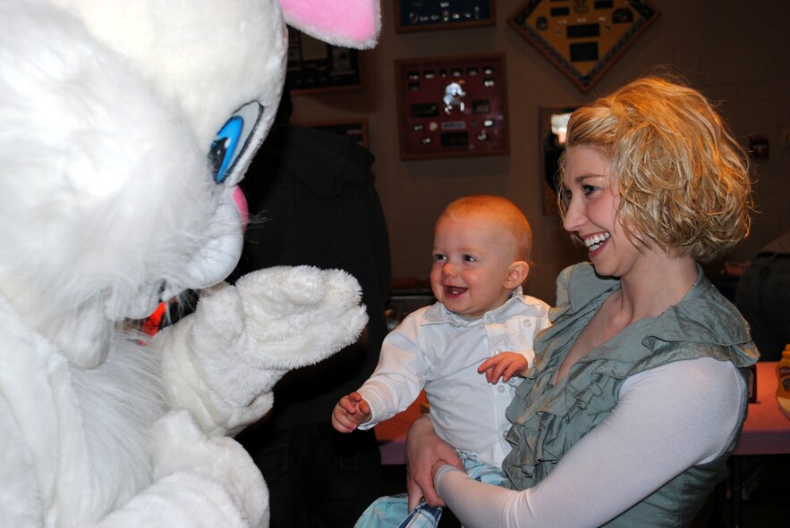 Jaymee Heflin, a mother attending the Spring Carnival, introduces her son Peyton, 10 months, to the Easter bunny.  The Easter bunny was walking around the event sharing hugs and high-fives with children in attendance.  (U.S. Air Force photo/Airman Cortney Hansen)