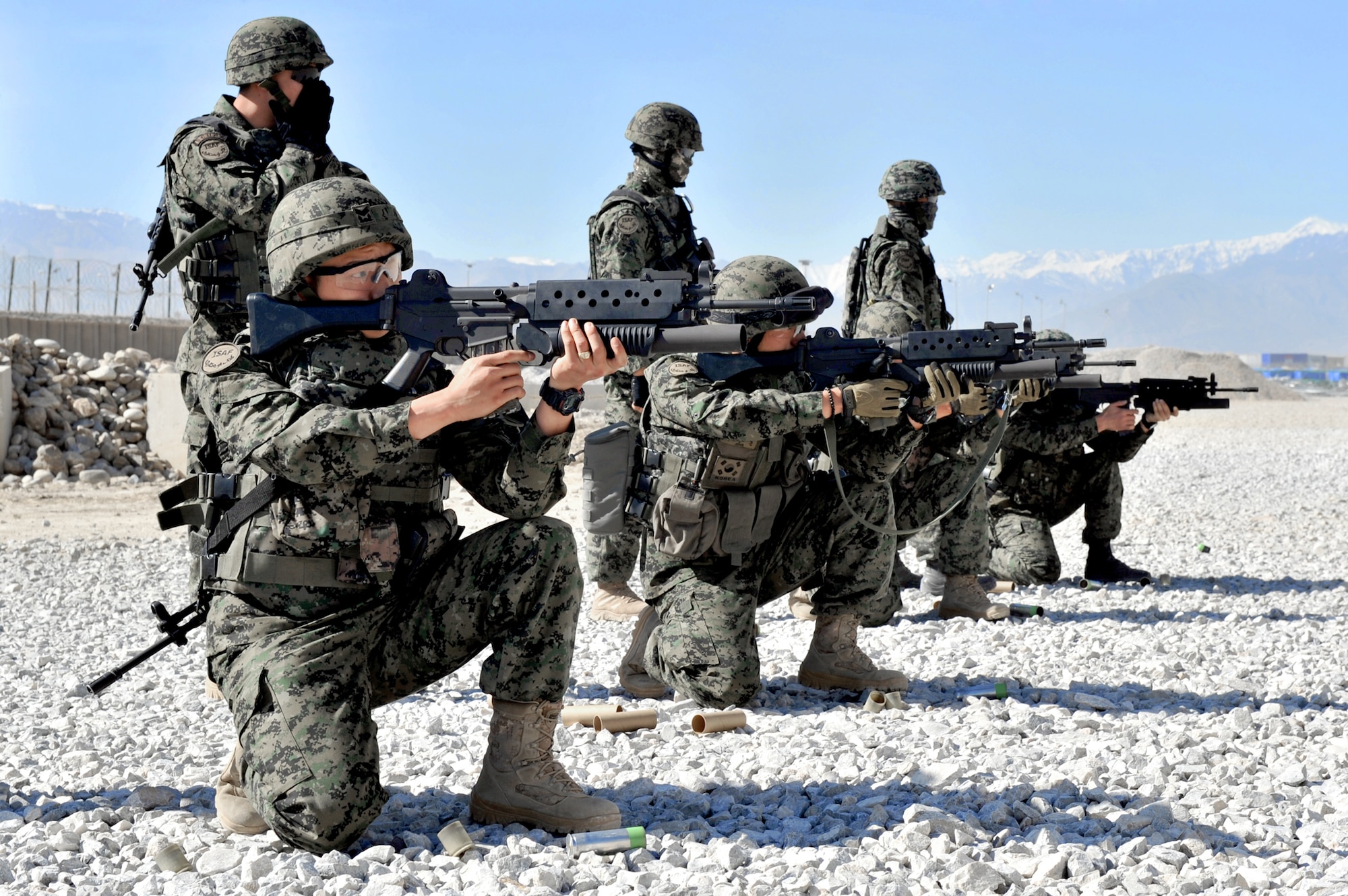 South Korean security forces soldiers take position before firing non-lethal munitions during escalation-of-force training at Bagram Airfield, Afghanistan, April 22, 2011. The soldiers have to qualify on the M203 grenade launcher before joining Bagram's base defense. (U.S. Air Force photo/Senior Airman Sheila deVera)