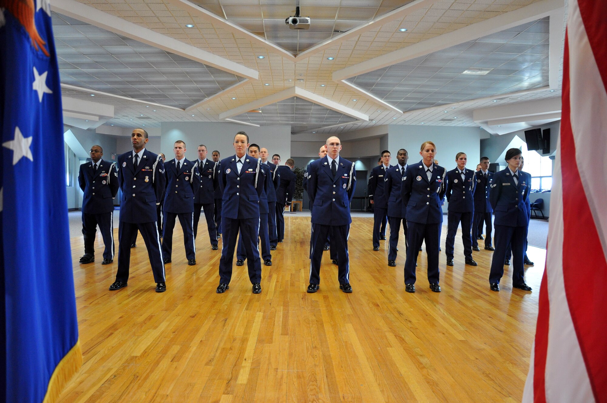 Members of Warren’s honor guard stand in open ranks formation as Staff Sgt. Fredrick Stewart, 90th Forces Support Squadron, and 1st Lt. Dane Skousen, 320th Missile Squadron, inspect them prior to Col. Greg Tims, 90th Missile Wing commander, presenting them with his commander’s coin April 21 in the Pronghorn Center here. (U.S. Air Force photo by Staff Sgt. Mike Tryon)
