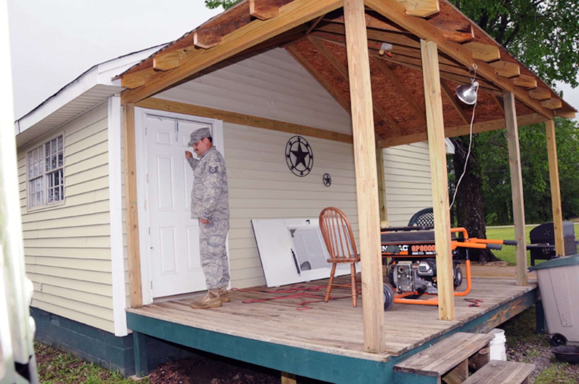 Tech. Sgt. Kevin Burrow knocks on a resident's door April 26, 2011, in Vilonia, Ark., during patrols after the community sustained damage to homes, power lines and businesses. Sergeant Burrows is a member of the 189th Airlift Wing's Rapid Augmentation Team Charlie patrol that checks on residents after severe weather damage. (U.S. Air Force photo/Master Sgt. Dianna Seerey)