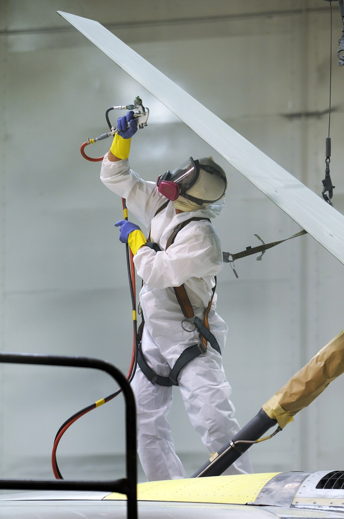 Painter Greg Mitchem sprays primer on the speed brake of an F-15 April 15. U. S. Air Force photo by Sue Sapp