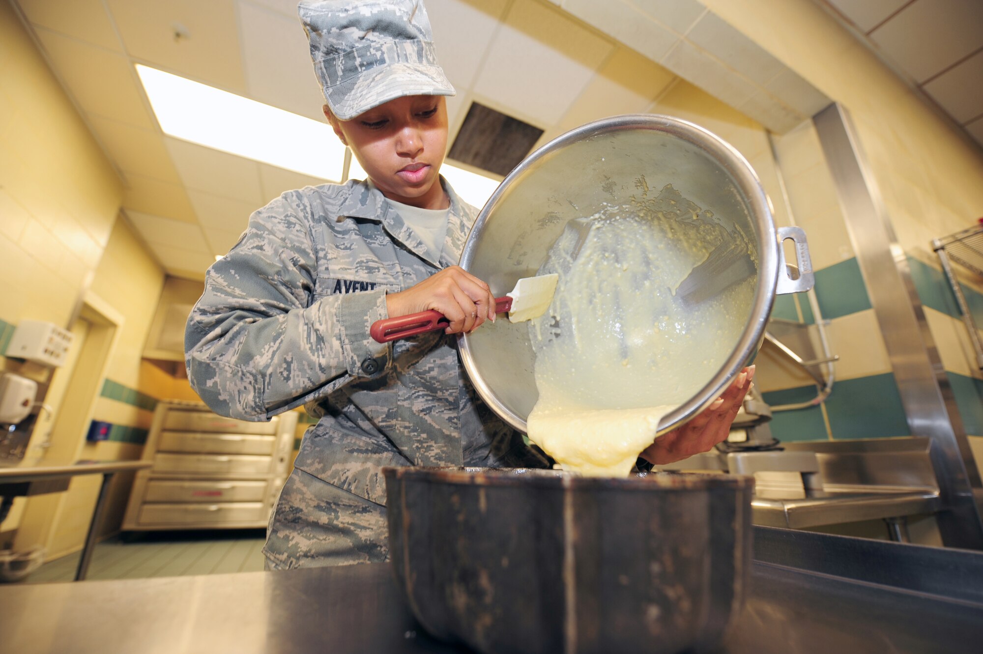 SEYMOUR JOHNSON AIR FORCE BASE, N.C. -- Airman 1st Class Precious Avent pours cake batter into a greased pan for baking at the Southern Eagle Dining Facility here, April 27, 2011. Airman Avent has worked as the head baker at the Southern Eagles Dining Facility for a year and said it is her favorite position in the kitchen. She has added seven new dessert items to the menu including her favorite, cake parfait. Airman Avent is a 4th Force Support Squadron services journeyman and hails from Henderson. (U.S. Air Force photo/Senior Airman Rae Perry) (RELEASED)