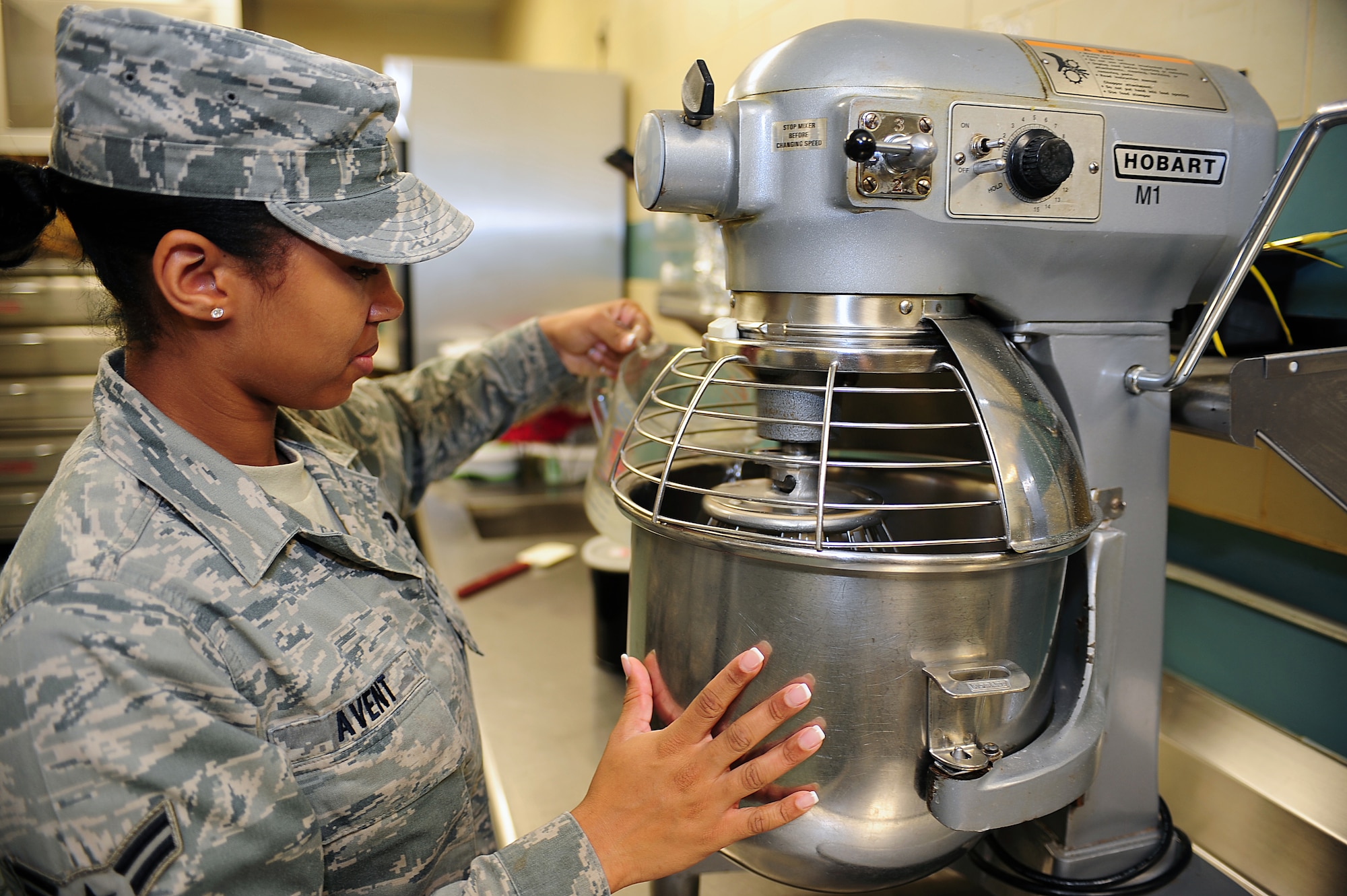 SEYMOUR JOHNSON AIR FORCE BASE, N.C. -- Airman 1st Class Precious Avent adds water to cake batter mixture at the Southern Eagle Dining Facility here, April 27, 2011. Airman Avent was selected as the Air Combat Command Hennessy Traveler and will attend a culinary class at the Culinary Institute of America at Greystone Campus in St. Helena, Calif., because of her hard work and dedication to her job as well as a willingness to learn new things. Airman Avent is a 4th Force Support Squadron food services journeyman and hails from Henderson. (U.S. Air Force photo/Senior Airman Rae Perry) (RELEASED)