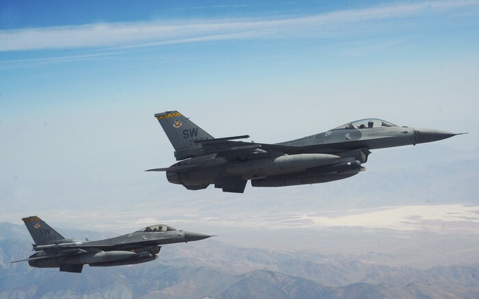 NELLIS AIR FORCE BASE, Nev. -- A two-ship of F-16 Fighting Falcons from the 79th Fighter Squadron, Shaw AFB, S.C., fly alongside a KC-135 Stratotanker April 25, after refueling during Green Flag West 11-6. Green Flag West provides a realistic close-air support training environment for Airmen and Soldiers preparing to deploy in support of combat operations.  (U.S. Air Force photo by Master Sgt. Kevin J. Gruenwald)