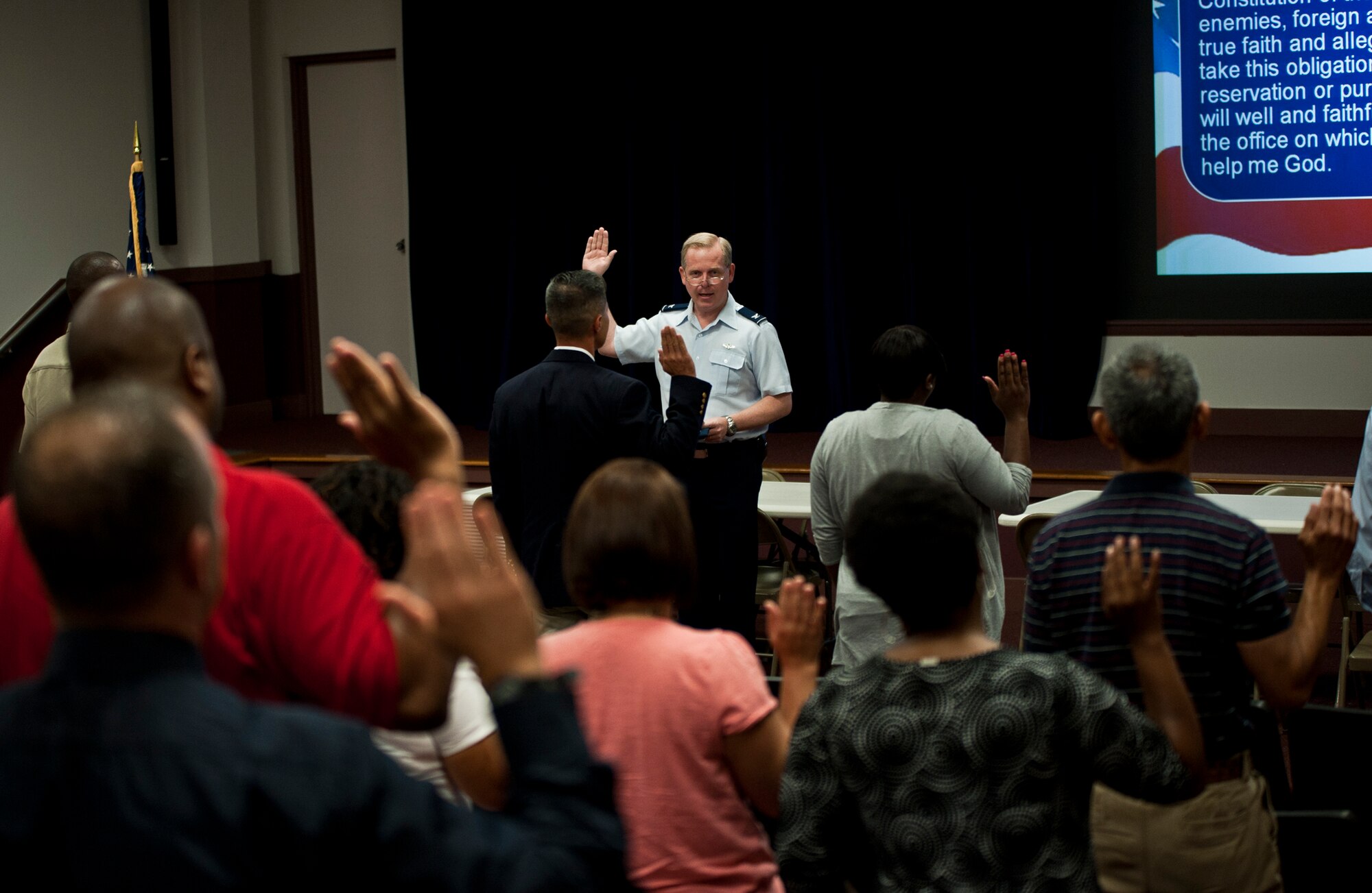 Col. David Harris, Air Armament Center vice commander, issues the oath of office to newly hired civilians at Eglin Air Force Base, April 25.  The group of newcomers were the first to complete the revamped civilian in-processing system.  The change was based on feedback from AAC's heavily civilian workforce.  (U.S. Air Force photo/Samuel King Jr.)
