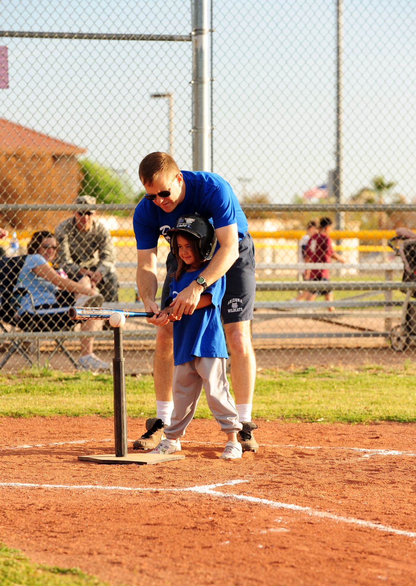 DAVIS-MONTHAN AIR FORCE BASE, Ariz. - Col. David Uselman, 355th Mission Support Group commander, assists a player on his little league tee ball team during a game at the Corsair ball field here April 20. Davis-Monthan currently has four tee ball teams comprised of children from the base community between the ages of five and six. (U.S. Air Force photo/Airman 1st Class Jerilyn Quintanilla)