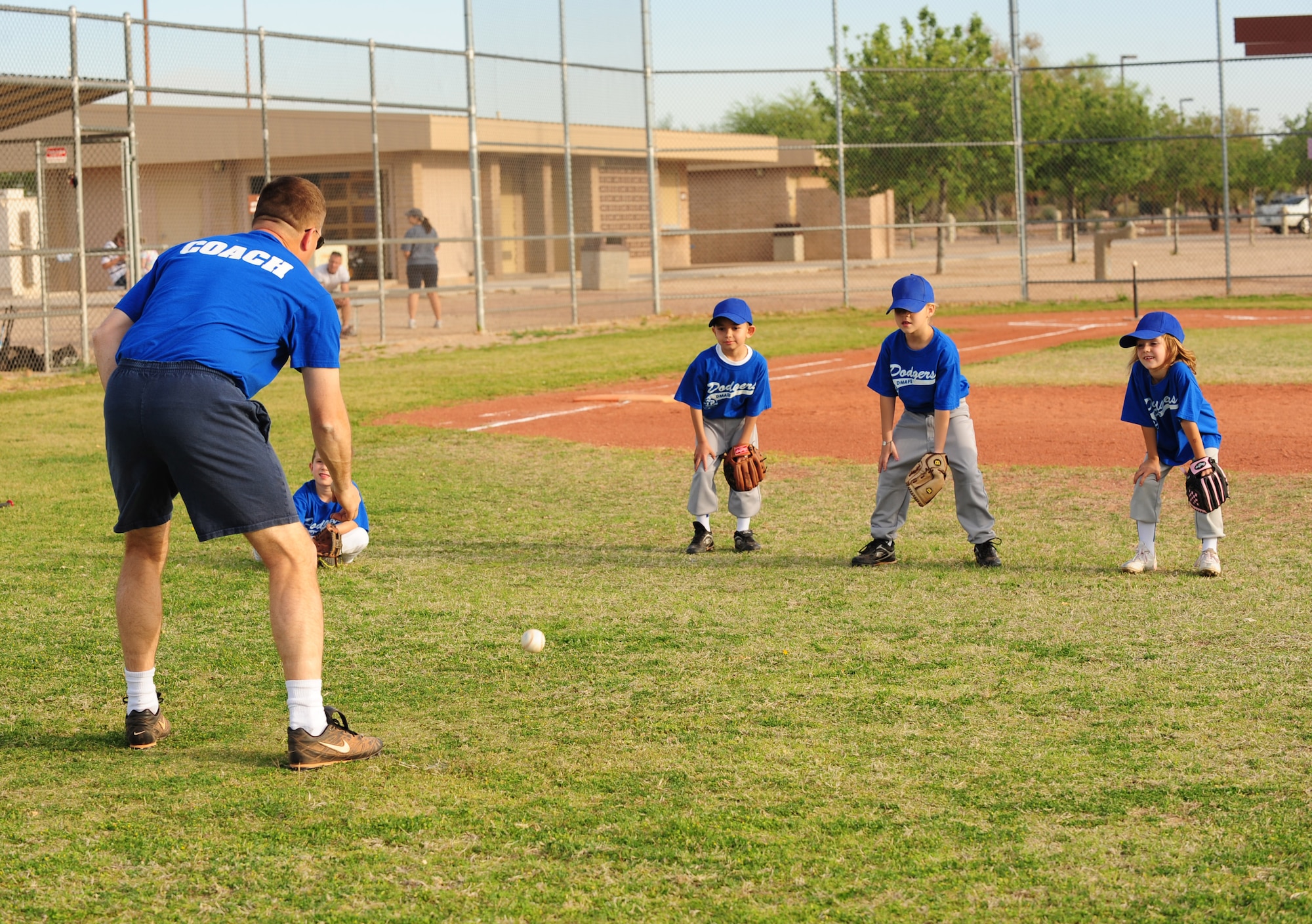 DAVIS-MONTHAN AIR FORCE BASE, Ariz. - Col. David Uselman, 355th Mission Support Group commander, runs drills with his little league tee ball team before a game at the Corsair ball field here April 20. The colonel volunteered to coach the D-M Dodgers tee ball team as part of a league for children between the ages of five and six. (U.S. Air Force photo/Airman 1st Class Jerilyn Quintanilla)