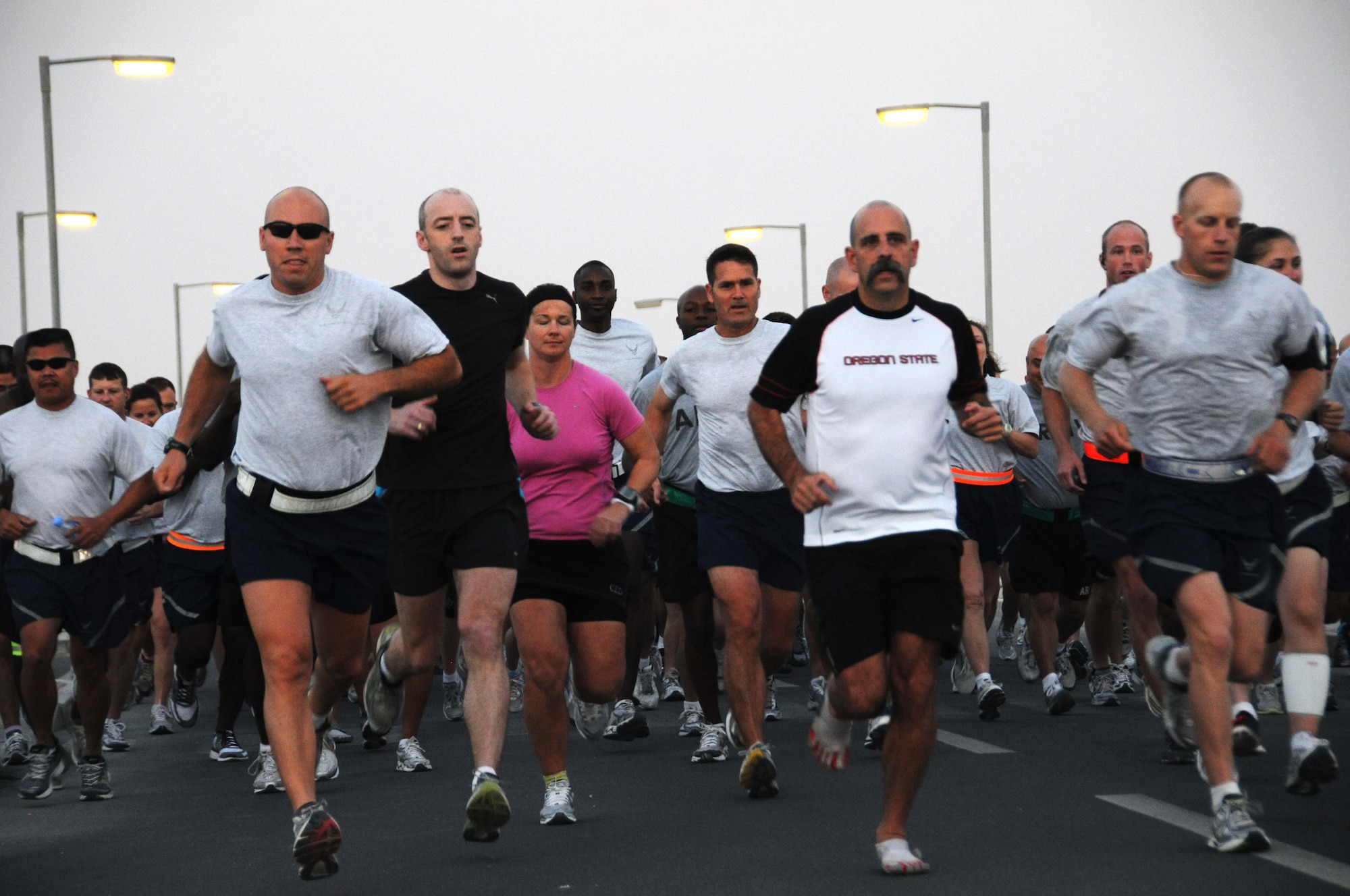 U.S. Service members, Civilians, and Foreign Military members take off at the beginning of a 10K run that was sponsored by the Stars & Stripes April 27 in Southwest Asia. (U.S. Air Force photo/Staff Sgt. Anthony Graham)