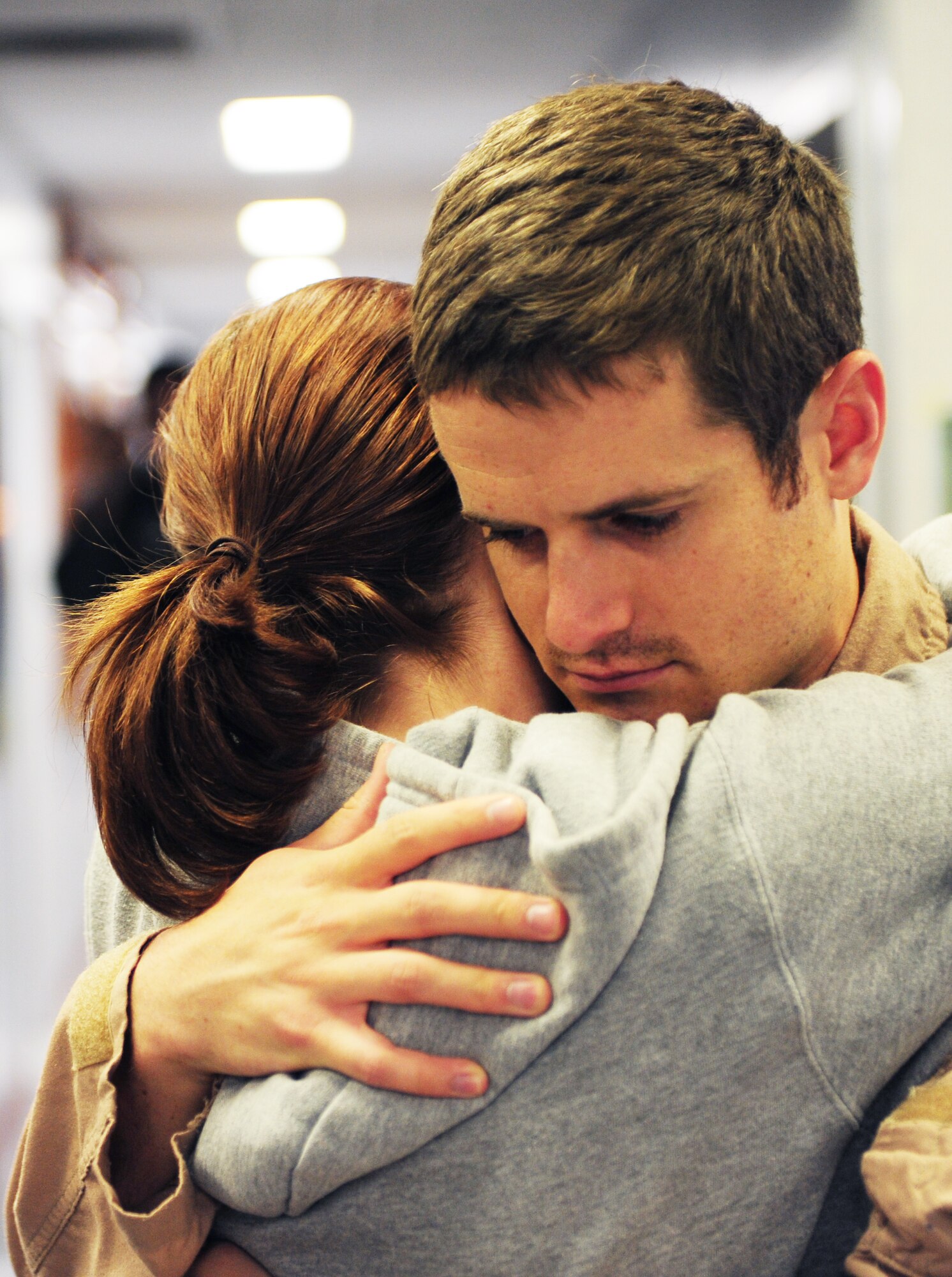 1st Lt. Daniel Rowland, 50th Airlift Squadron pilot, hugs his wife before he deploys on April 28, 2011, at Little Rock Air Force Base, Ark. Airmen and aircraft from the 50th Airlift Squadron “Red Devils” leave for deployment to Southwest Asia. This is the first deployment of Airmen and aircraft from Little Rock Air Force Base following an F-2 tornado that struck the base the evening of April 25 and damaged more than 100 on-base housing units, damaged three C-130 aircraft and blew the roofs off and damaged many buildings in the base's flightline area. (U.S. Air Force photo by Senior Airman Jim Araos)