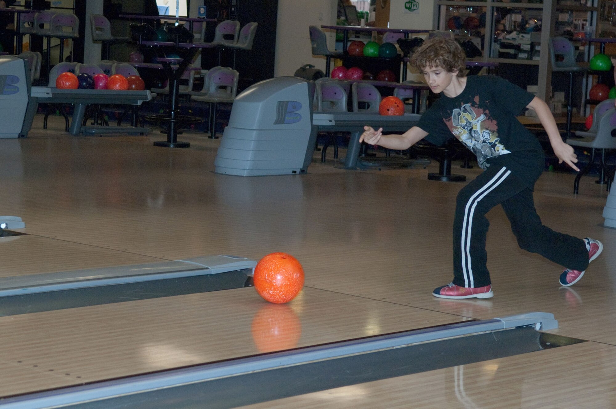 HANSCOM AIR FORCE BASE, Mass. - Justin Saunders aims for a strike during the World Wide Youth Bowling tournament at Hanscom Lanes April 19. Youth, ages 9 to 18, were invited to the annual event. The names of top three scorers in each age category are being compiled and will be submitted for a chance to compete at the Air Force-level. (U.S. Air Force photo by Rick Berry) 