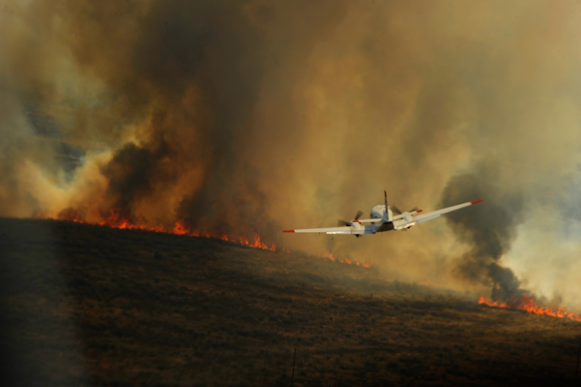 A U.S. Department of Agriculture, Forest Service King Air lead plane guides a C-130J Hercules from the 146th Airlift Wing during firefighting operations in Scurry County, Texas, April 27, 2011.  The lead planes guide aircraft to ensure that the fire retardant is dispensed where it is needed.  Wildfires have spread across various parts of Texas and have burned more than 1,000 square miles of land.  (U.S. Air Force Photo/Staff Sgt. Eric Harris)

