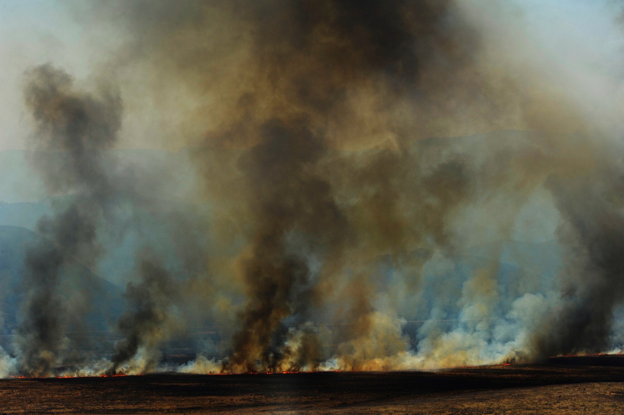 A wildfire burns in West Texas as fire fighting crews try to contain it, April 27, 2011.  Wildfires have spread across various parts of Texas and have burned more than 1,000 square miles of land.  (U.S. Air Force Photo/Staff Sgt. Eric Harris)