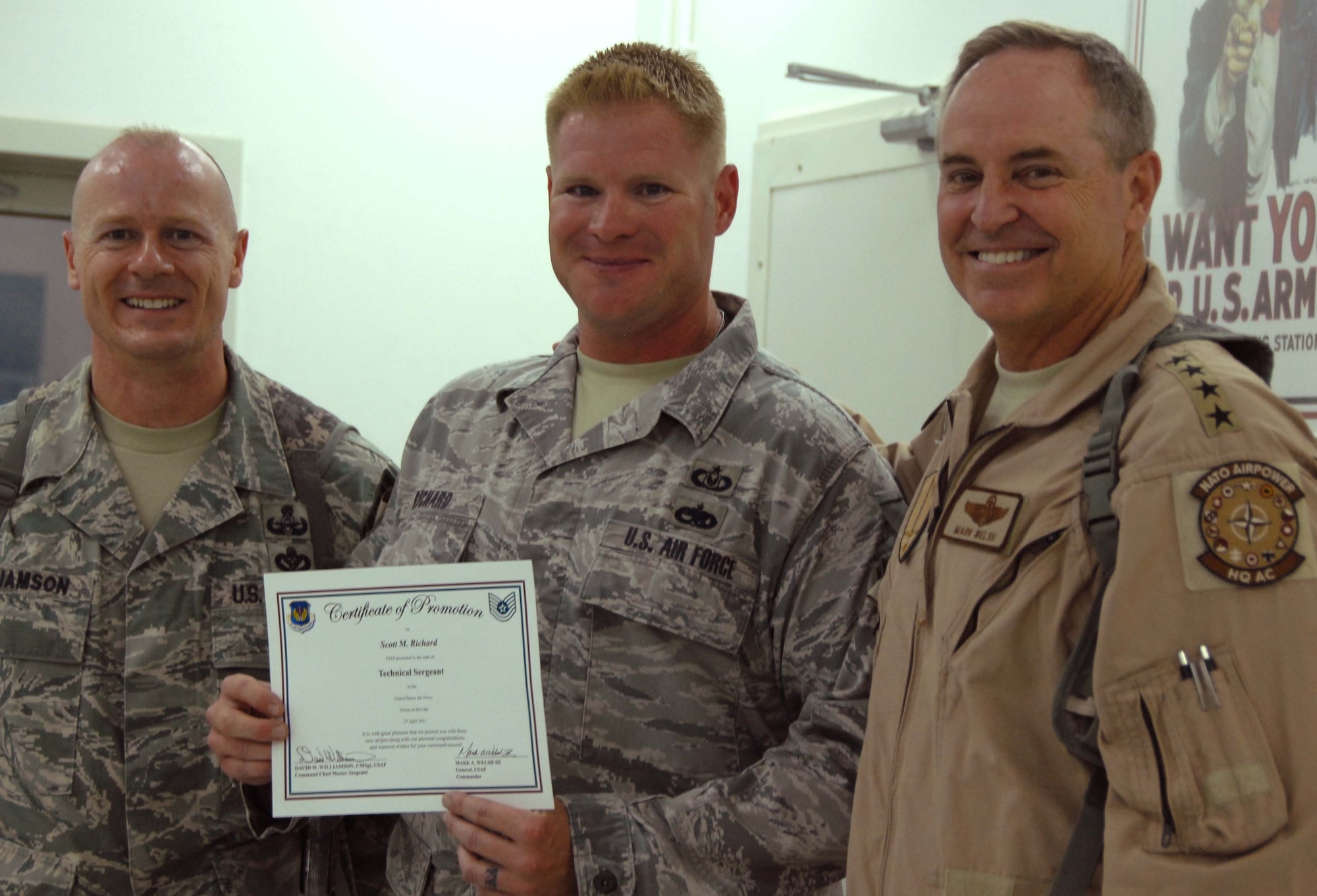 General Mark Welsh, commander, U.S. Air Forces in Europe and Command Chief Master Sgt. David Williamson congratulate newly promoted Tech. Sgt. Scott Richard during a visit to Kandahar Airfield April 27, 2011. Tech. Sgt. Richard is the NCOIC of ground safety for the 451st AEW at the airfield. (Photo by Tech. Sgt. Emily F. Alley)