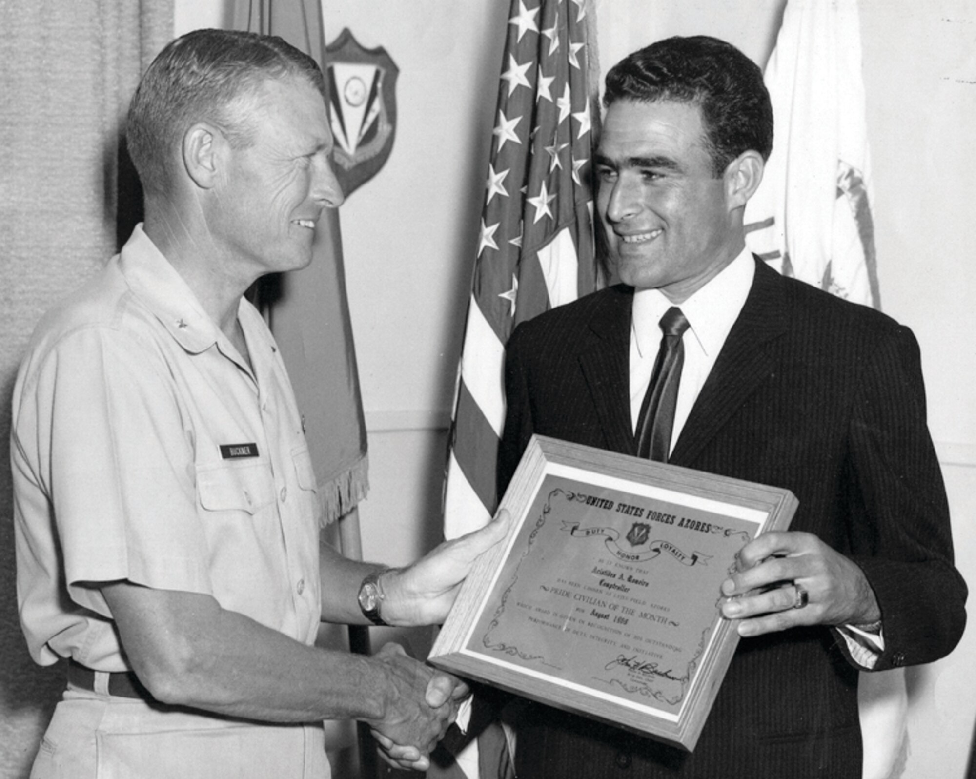 Brig. Gen. William Buckner shows his appreciation to Senhor Aristides Romeiro, father of Arsenio Romeiro, during his time serving in the comptroller's office from 1955 to 1993.  Senhor Romeiro is one of three generations to work at Lajes Field, Azores. (Courtesy photo) 