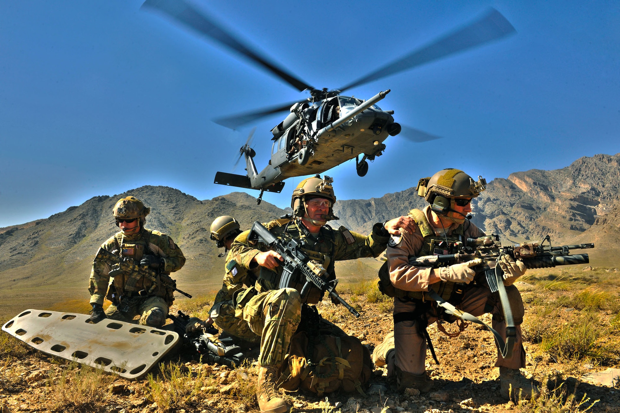 An HH-60G Pave Hawk deployed from the 33rd Rescue Squadron hovers over pararescuemen during a training mission at Bagram Airfield, Afghanistan, Sept. 24, 2010. The training mission provided a glimpse of what the 33rd Rescue Squadron brings to the fight and the capabilities it provides to combat commanders. (U.S. Air Force photo illustration/Staff Sgt. Christopher Boitz and Senior Airman Shaunlee Hostutler)
