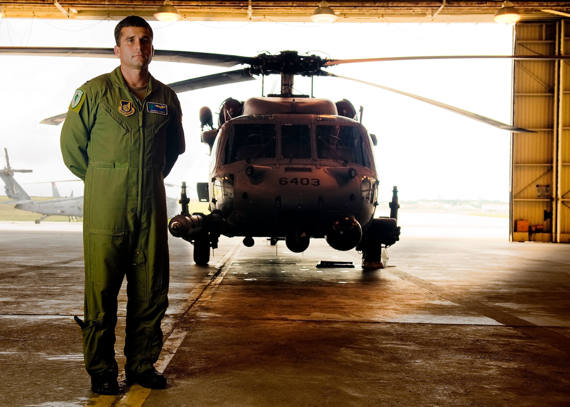 Capt. Marcus Maris, an HH-60 Pave Hawk helicopter pilot, poses in front of his aircraft. Captain Maris and 12 other Airmen from the 33rd Rescue Squadron are being recognized as the recipients of the "Jolly Green Association Rescue Mission of the Year" award. This marks the third year in a row that the rescue squadron has claimed the award. (U.S. Air Force photo illustration/Staff Sgt. Jonathan Steffen and Senior Airman Shaunlee Hostutler)