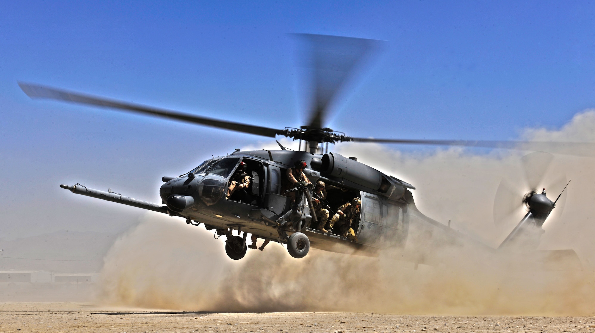 An HH-60G Pave Hawk helicopter carrying combat search and rescue Airmen from the 33rd Rescue Squadron approaches a landing zone during an exercise at Bagram Airfield, Afghanistan, Aug. 21. 2010. (U.S. Air Force photo illustration/Staff Sgt. Christopher Boitz and Senior Airman Shaunlee Hostutler)