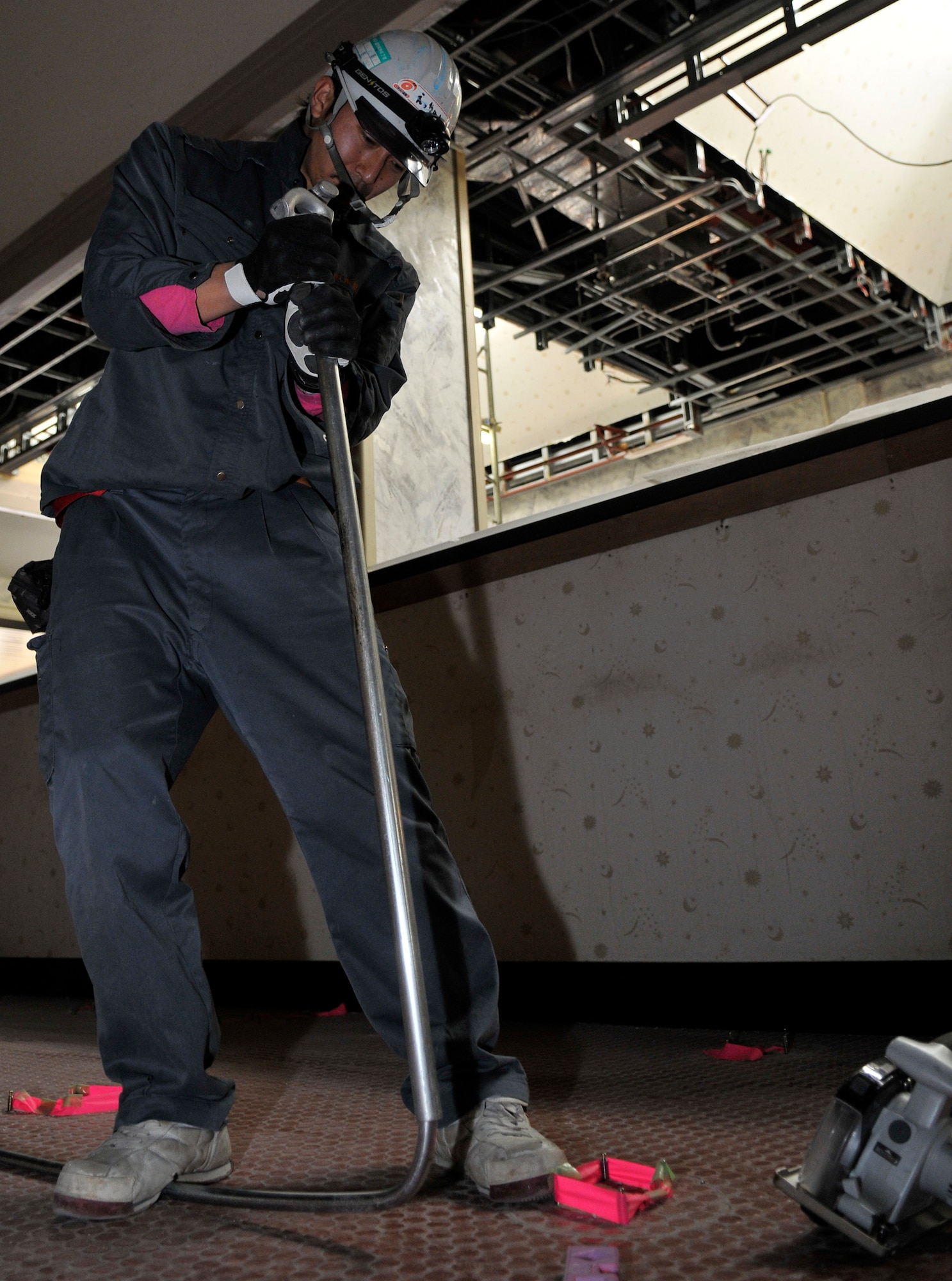 MISAWA AIR BASE, Japan – Echigo Takeshi, a Japanese contractor, bends a metal pipe April 26. As part of the Walmsley Bowling Center’s renovation, old electrical wires are being replaced for safety and efficiency. (U.S. Air Force photo/Tech. Sgt. Phillip Butterfield)