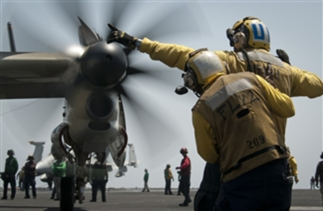 Aviation boatswain's mates (handling) direct an E-2C Hawkeye aircraft aboard the aircraft carrier USS Carl Vinson (CVN 70) in the Arabian Sea on April 26, 2011.  The Carl Vinson and Carrier Air Wing 17 are conducting maritime security operations and close-air support missions in the U.S. 5th Fleet area of responsibility.  