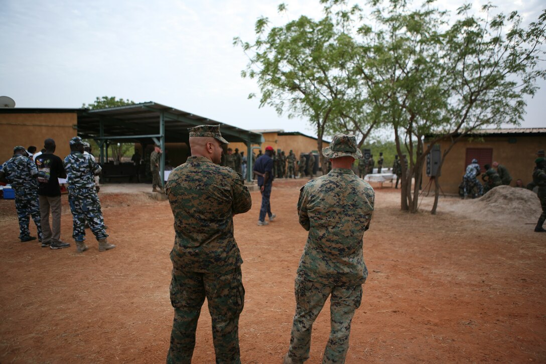 1st Sgt. Edwin Maldonado [left] and 1st Sgt. Jason Moffitt look on at the evening’s festivities during a Warrior’s Night here, recently. Maldonado, senior enlisted advisor for Security Cooperation Task Force Africa Partnership Station 2011 and Moffitt, company first sergeant for Ground Combat Element, SCTF APS-11 overlooked the evening’s events as U.S. Marines, Senegalese Commandos and Nigerian Navy Special Boat Service operators indulged in good food, music, and cold drinks at the end of a demanding three-week military exchange. (U.S. Marine Corps photo by Lance Cpl. Timothy L. Solano)