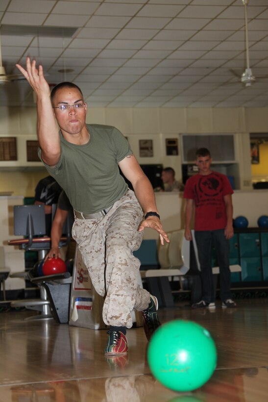 Pfc. Aaron W. Mossor launches his bowling ball down the lane during the Navy-Marine Corps Relief Society Bowling Tournament at the Stars N’ Strikes Bowling Alley April 29. The NMCRS fund drive ran throughout the month of April and Cherry Point raised more than $4,000 between donations and the two fund drive events. Mossor is a motor-transport operator with Marine Air Control Squadron 2.